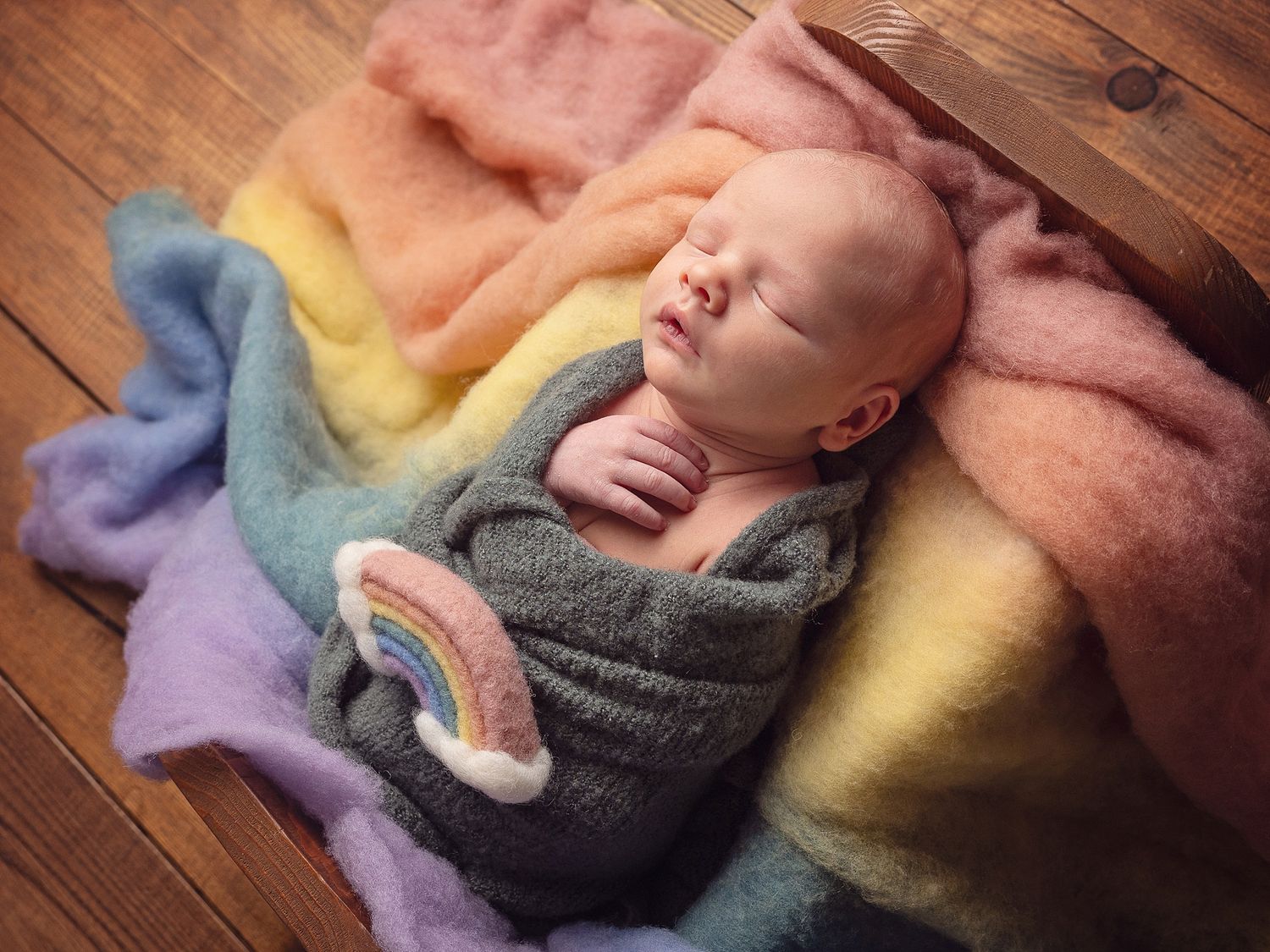 baby on rainbow fabric with rainbow