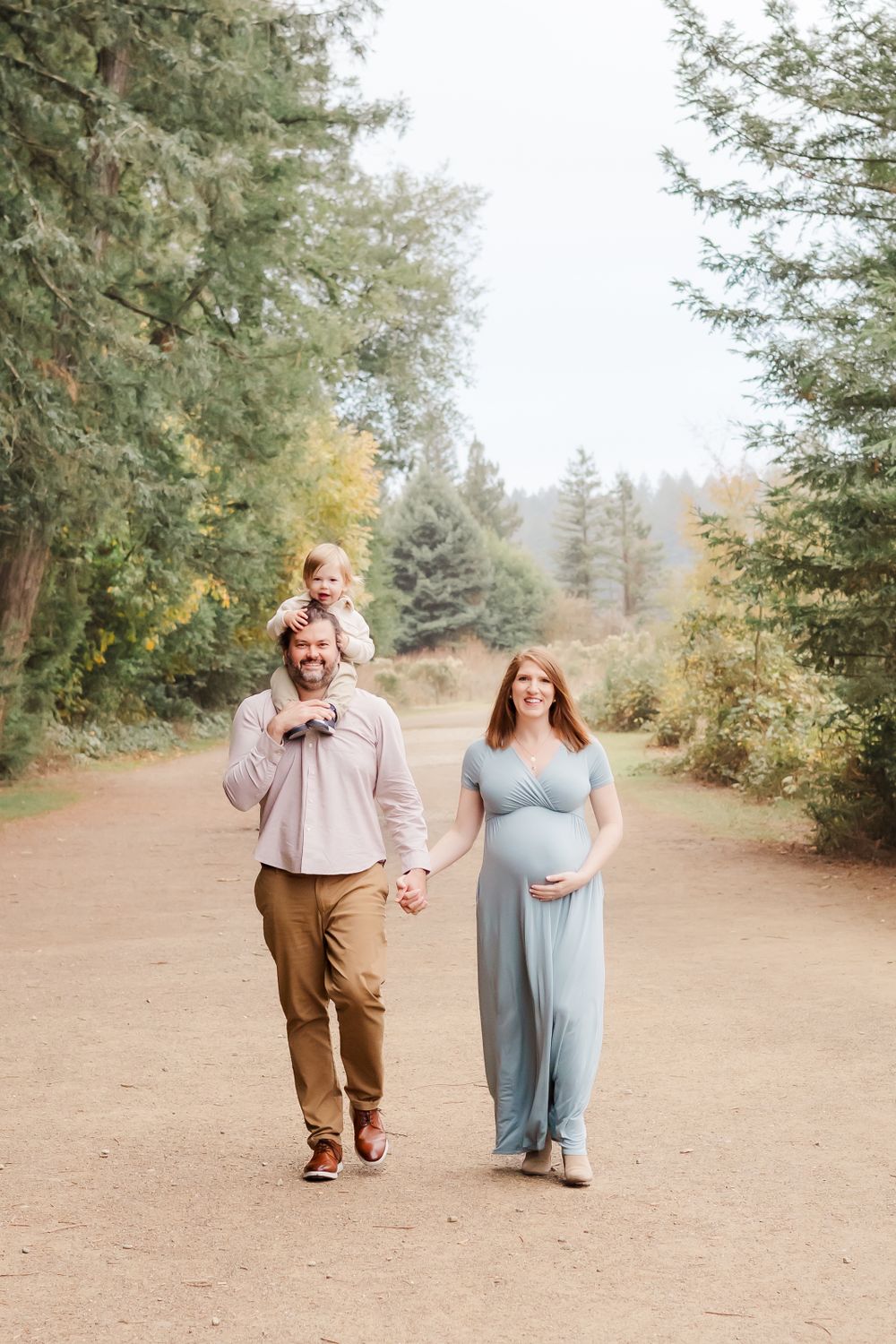 maternity session in Sonoma County. family walking together and mom holding her pregnant belly.