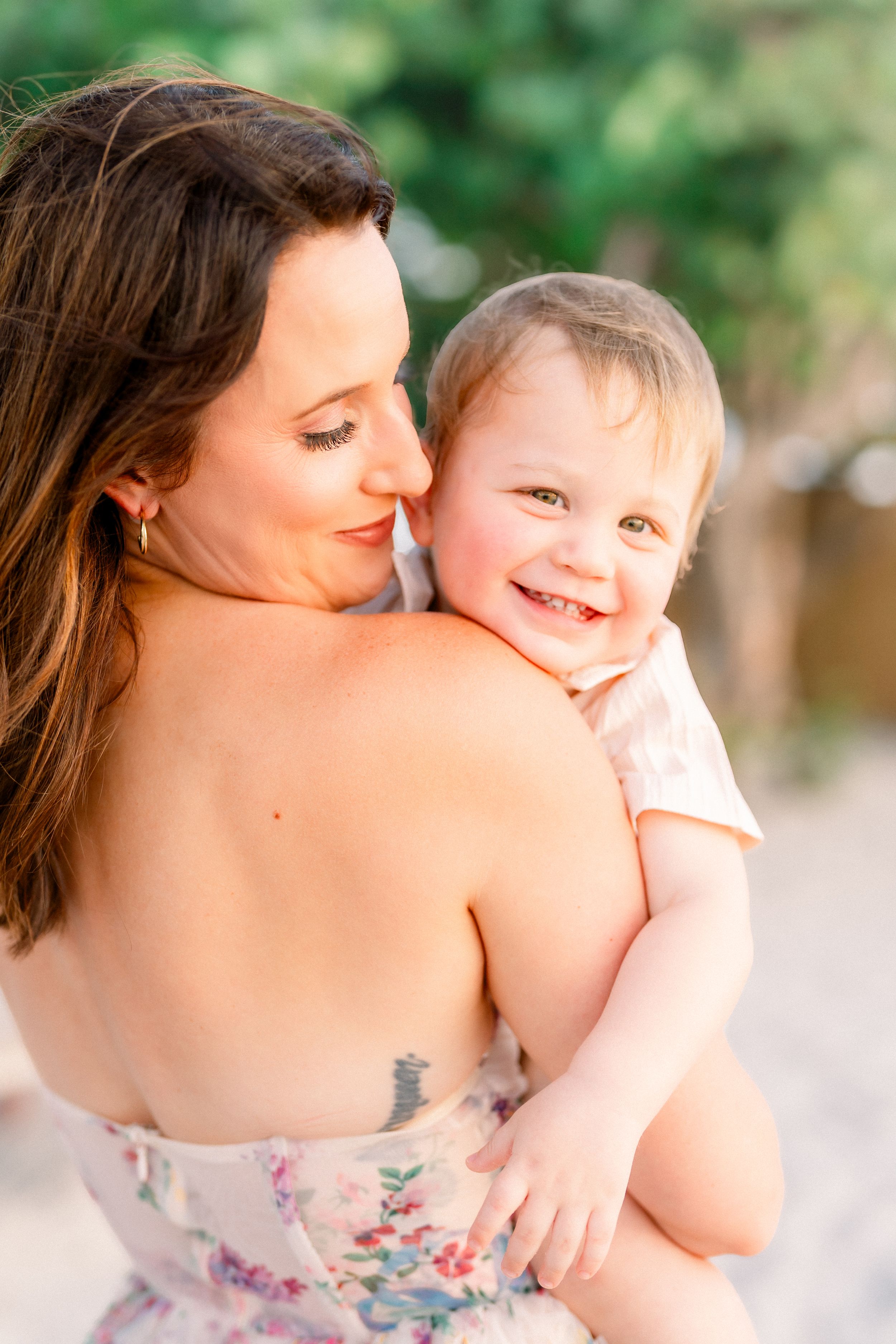 all smiles from baby brother as he hugs his momma on St. Pete Beach during their family session