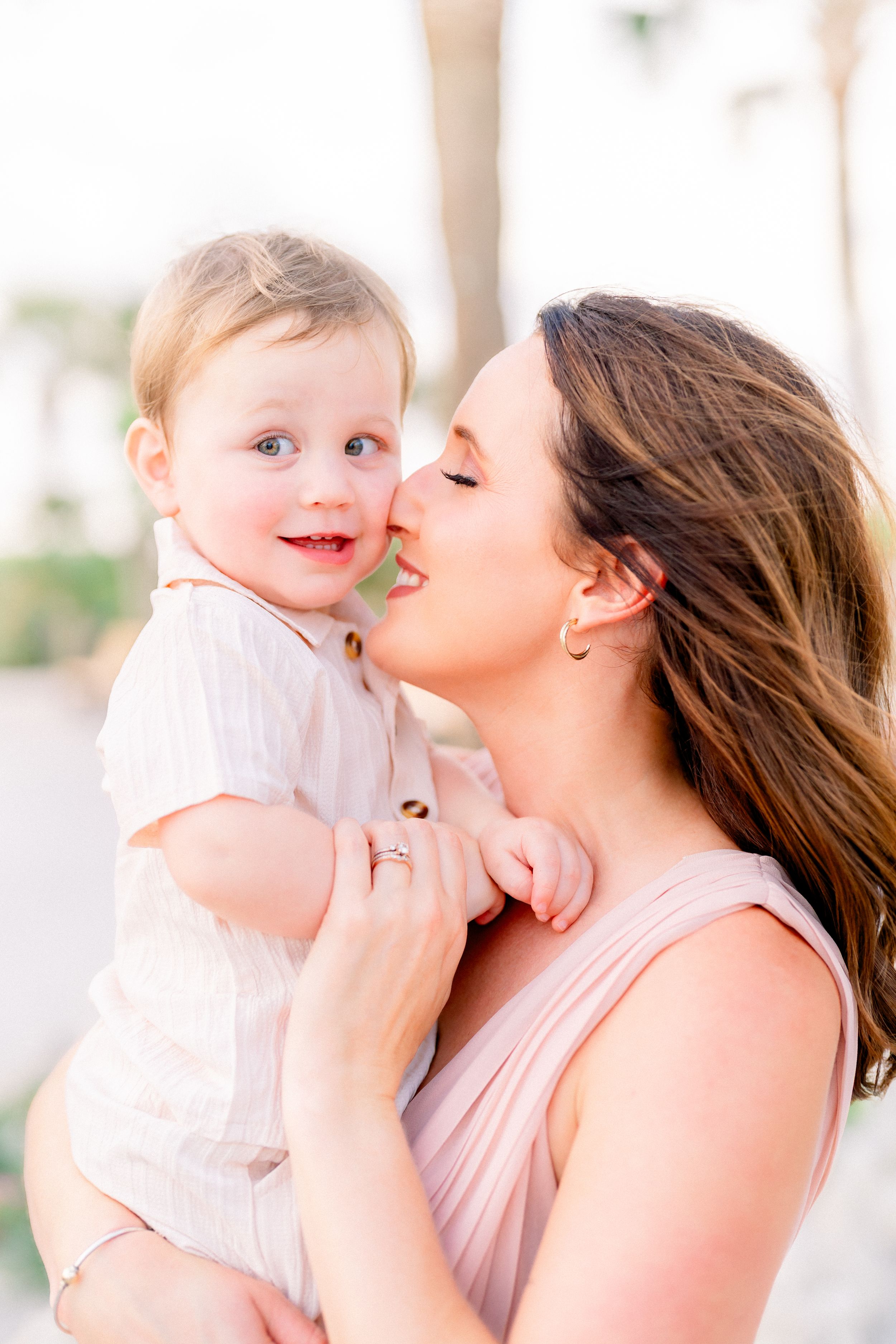more kisses from mom for baby boy during a family photoshoot on St. Pete Beach