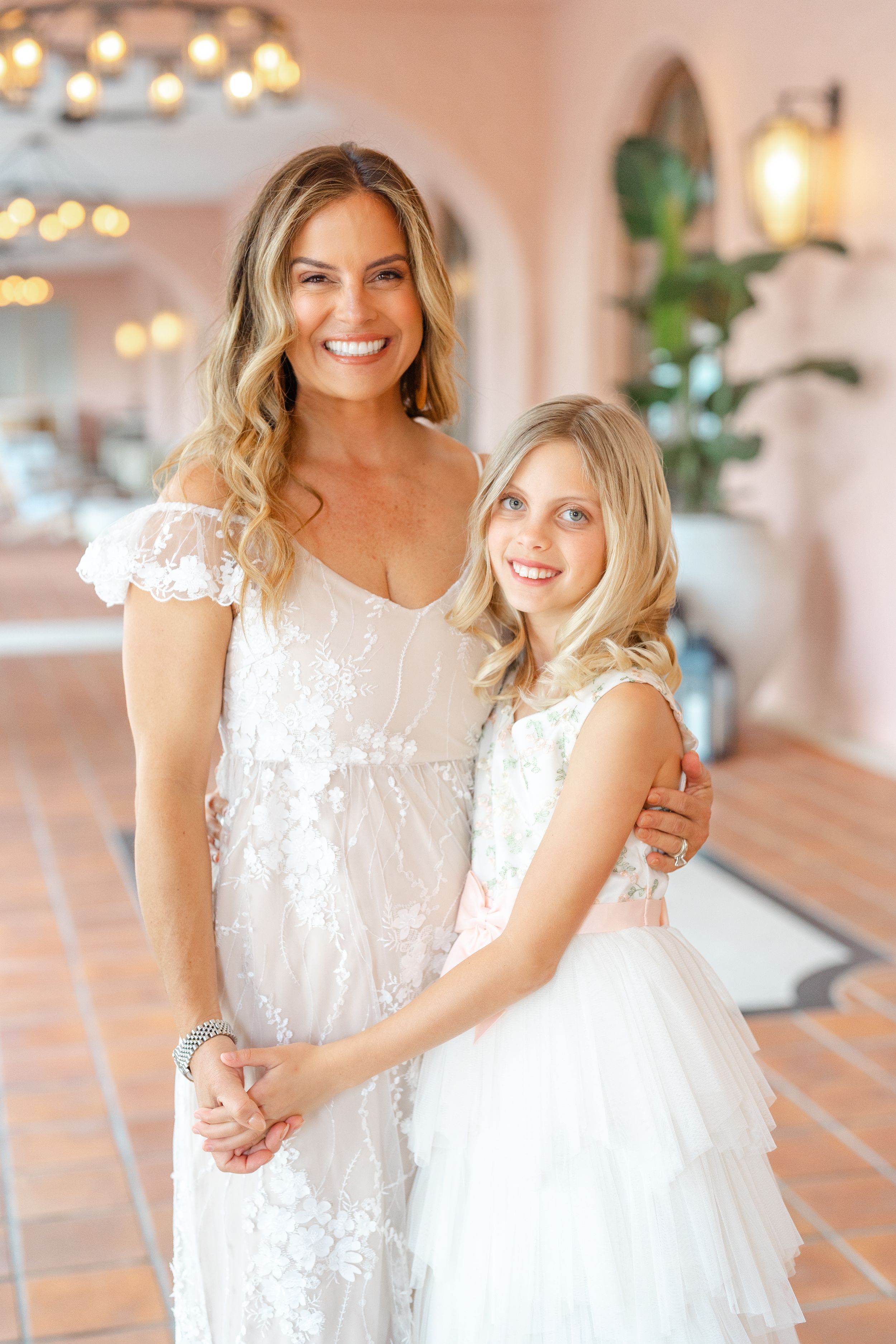 mother and daughter holding hands with their foreheads together and big smiles at The Vinoy in St. Pete FL during their family photoshoot.
