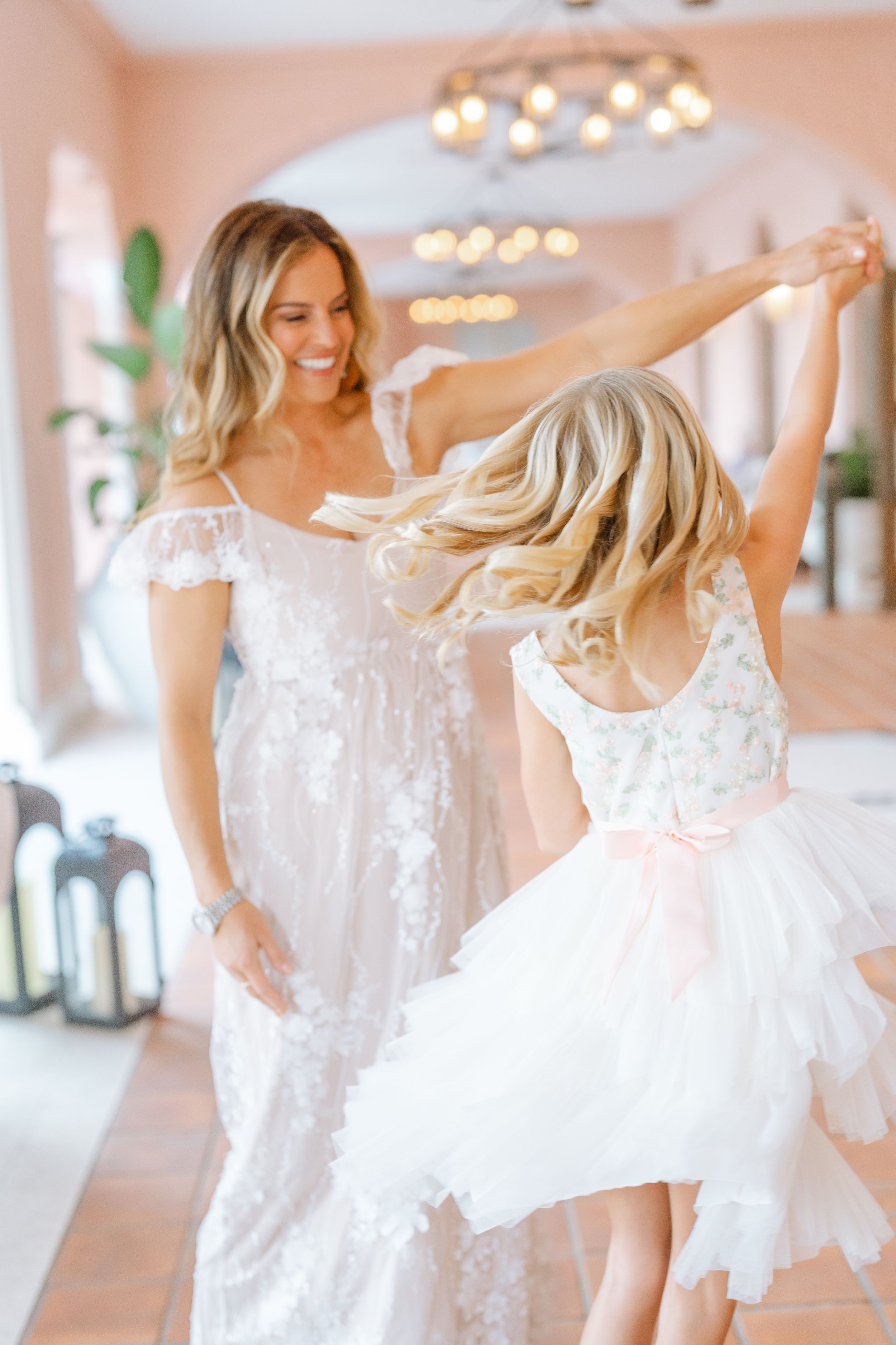 mother and daughter dancing together with big smiles at The Vinoy in St. Pete FL during their family photoshoot.