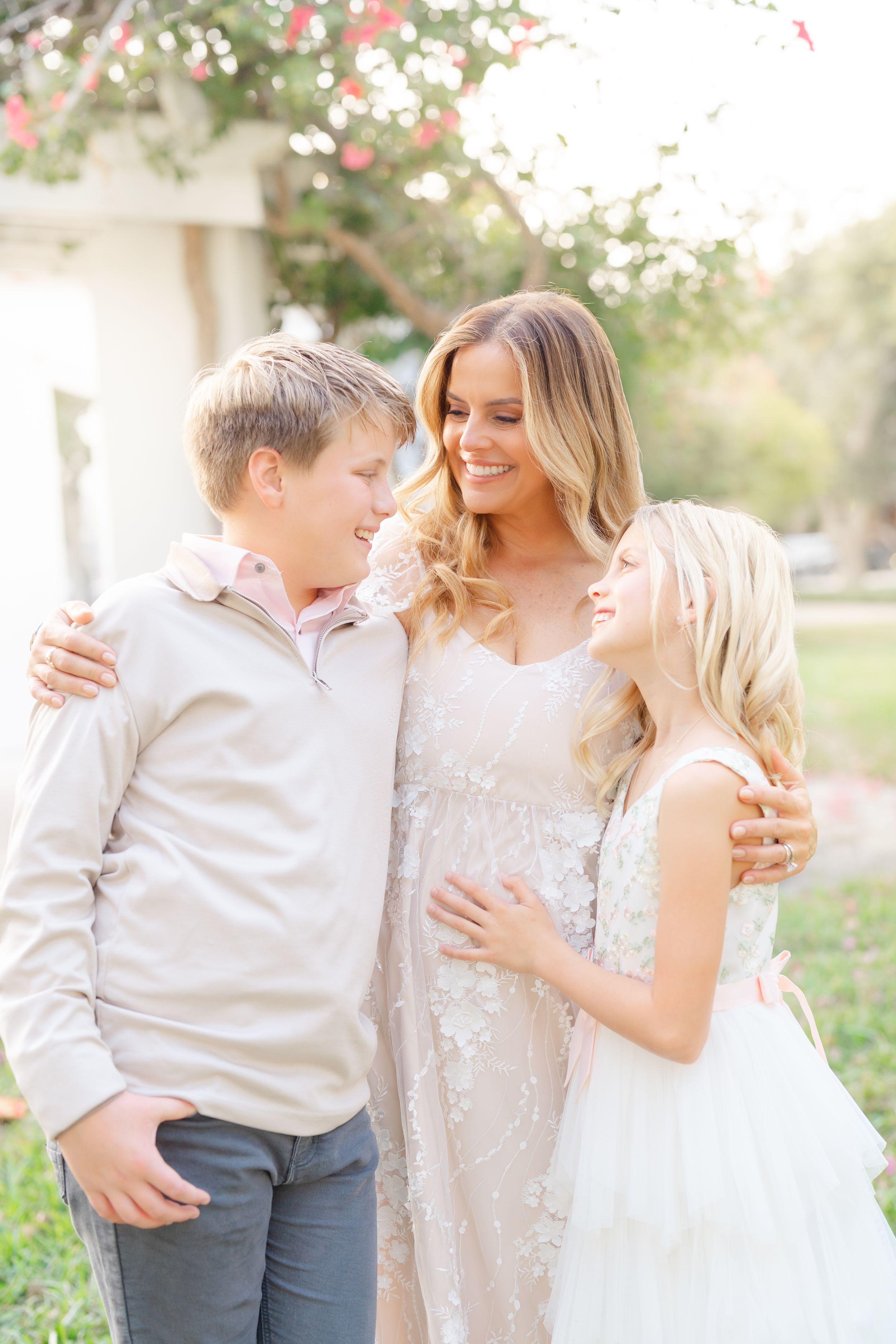 mother and kids cuddling together with big smiles at The Vinoy in St. Pete FL during their family photoshoot.