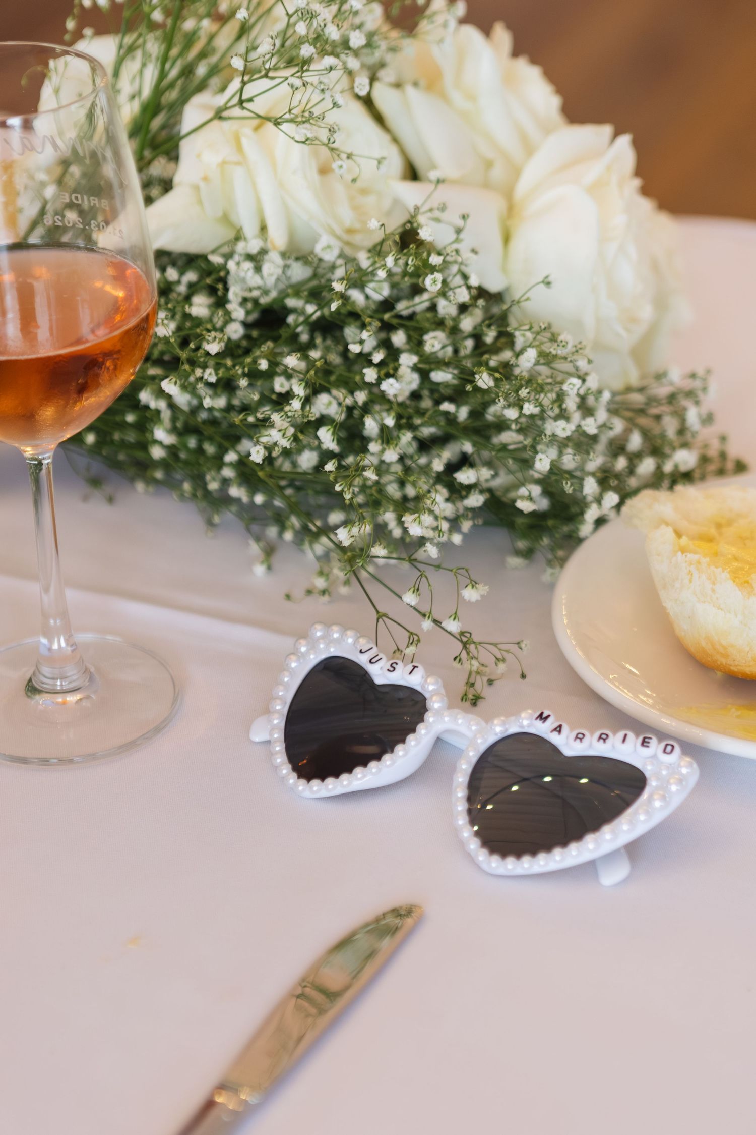 Flowers and sunglasses on table at Two Rivers Winery Wedding in Denman