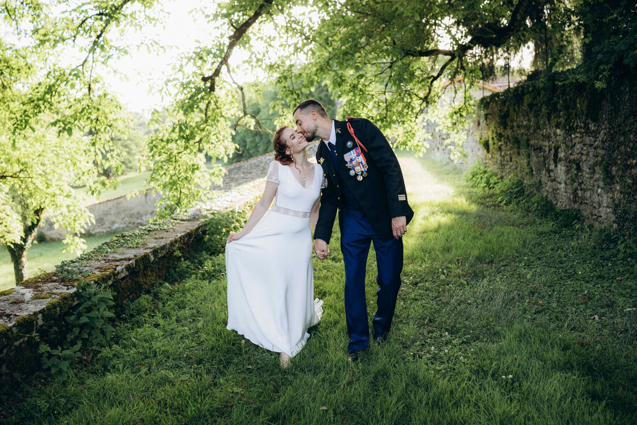 A romantic dance silhouette under stone archways with warm lighting.