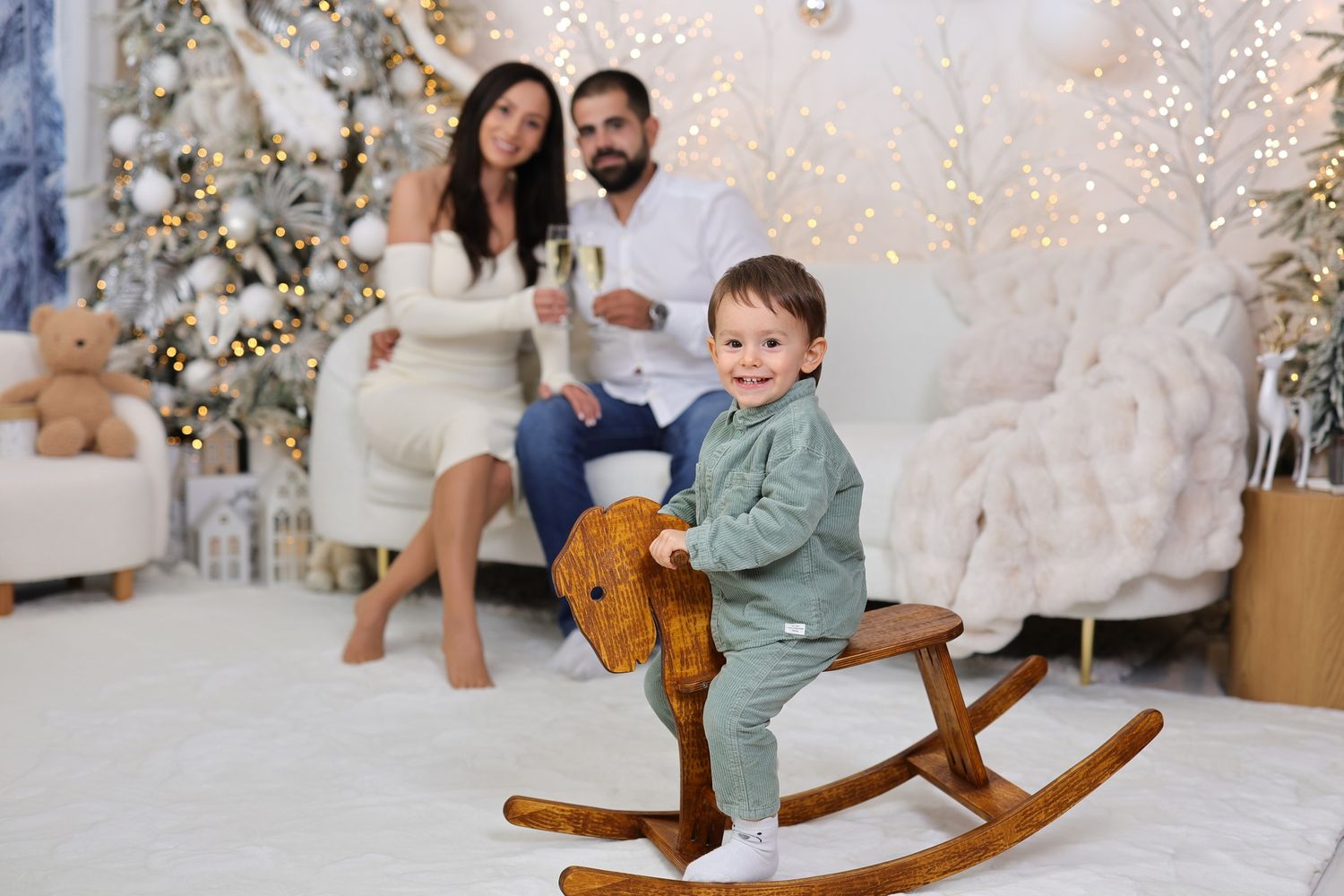 Winter wonderland themed photography set with rocking horse and sparkling holiday decorations.
