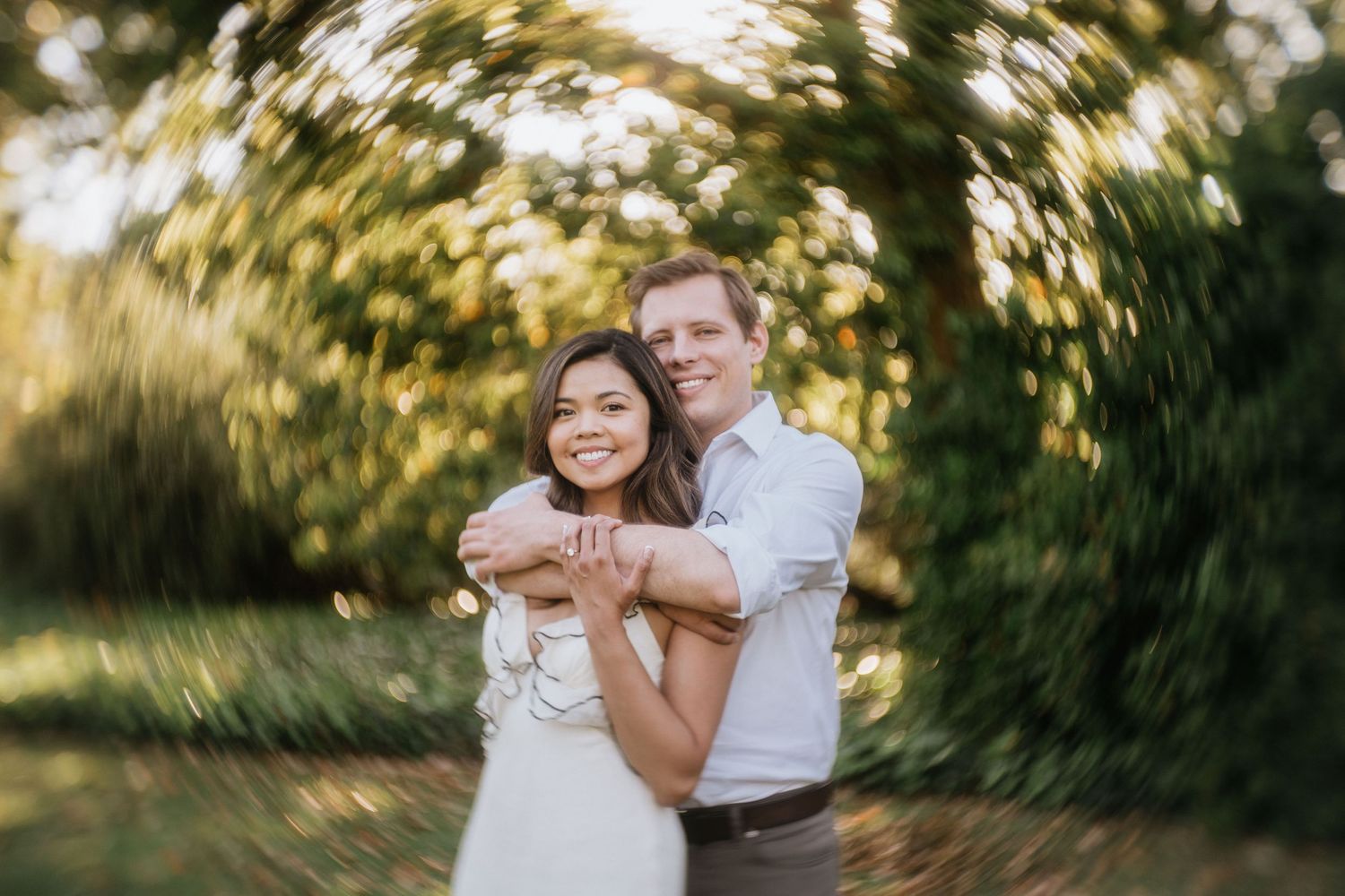 Mariel and Jeff embracing during their engagement session at the Los Angeles County Arboretum.