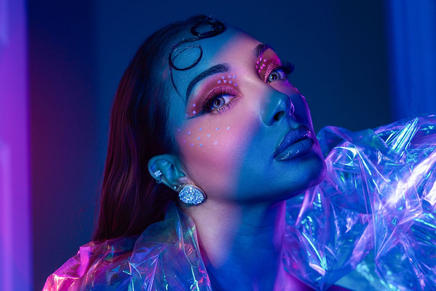 Orlando creative photographer Ray Alvarez — bold editorial portrait with blue gel lighting and dramatic makeup
