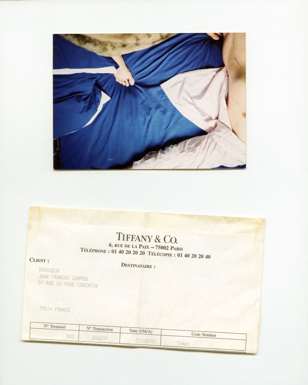 Photo of a person in blue dress on bed beside a Tiffany & Co. Paris invoice document.