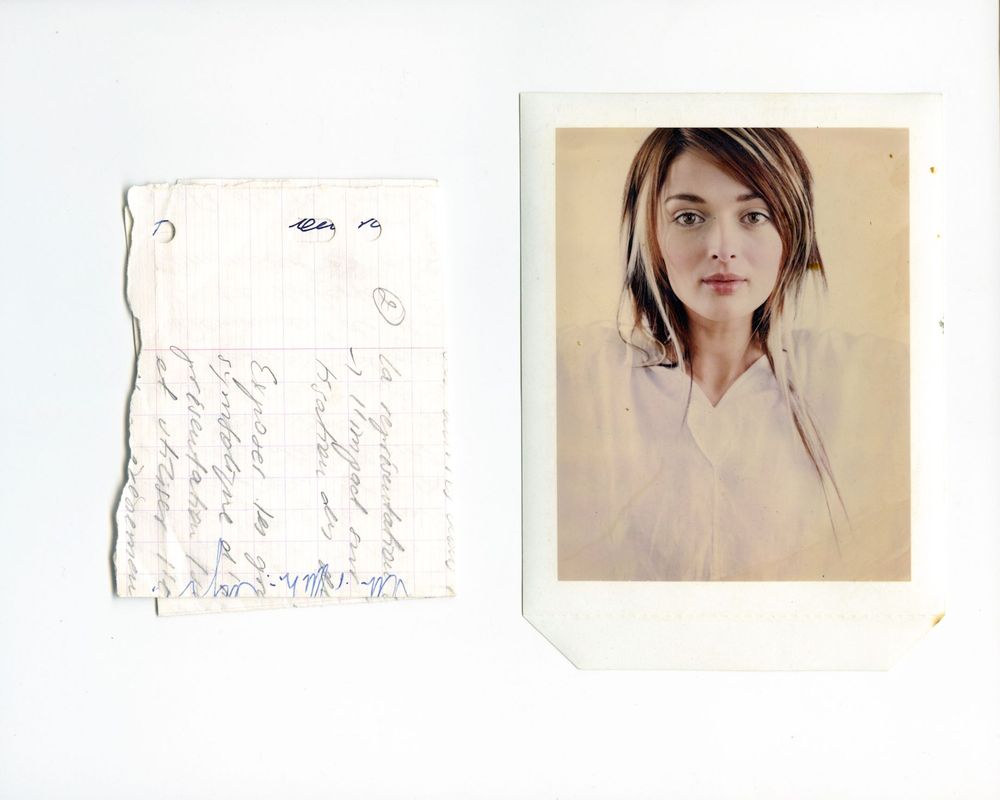 A Polaroid portrait of a young woman beside a handwritten note on aged paper, mounted on white background.