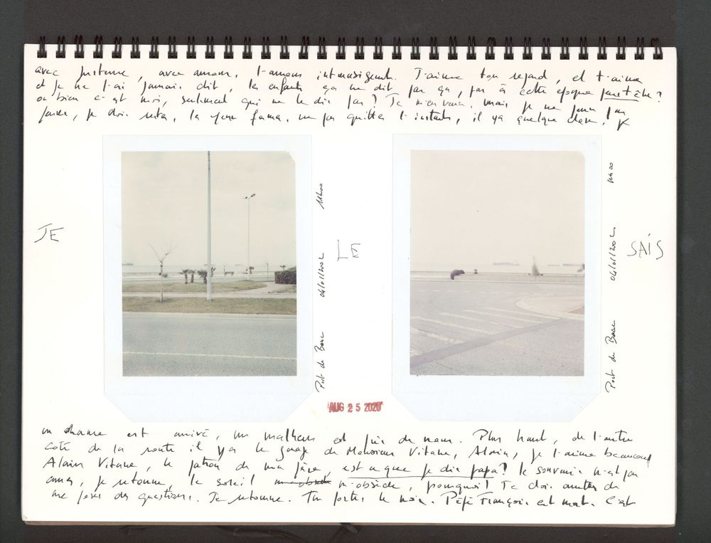 A spiral-bound journal with handwritten notes and two small photographs of flat landscapes pasted on its pages.