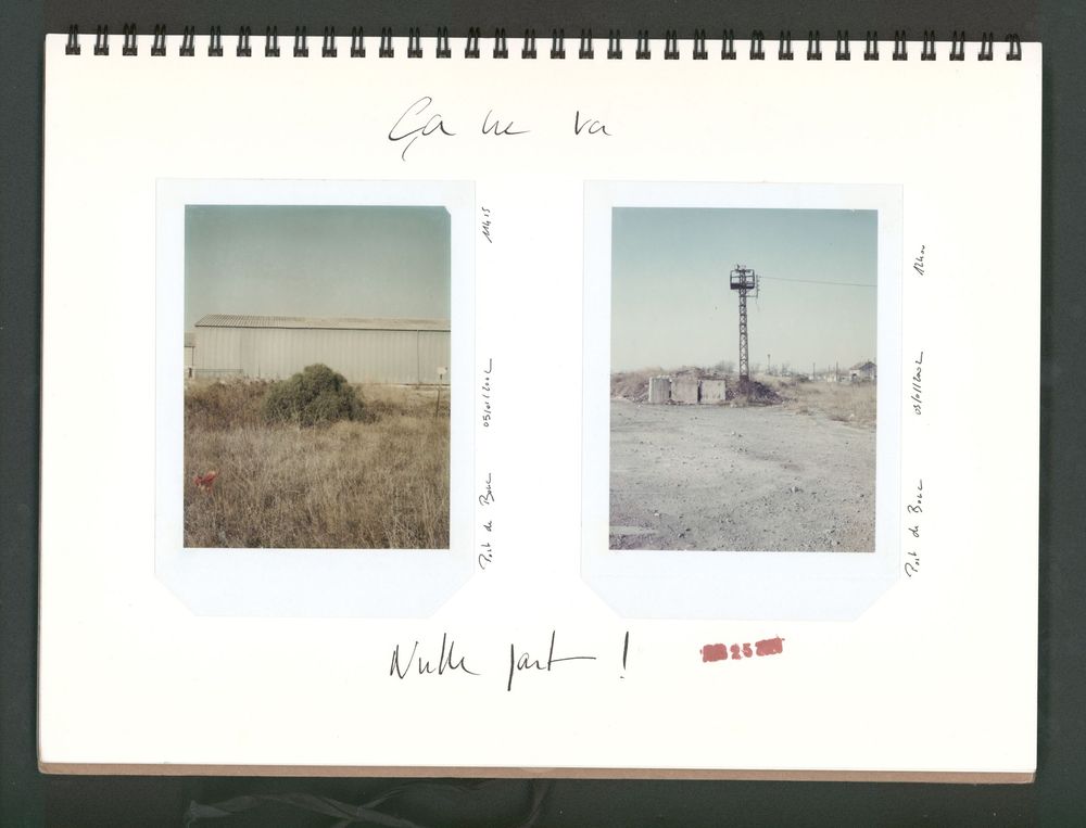 Two vintage Polaroid photos in a spiral notebook showing arid landscapes with a fence and a water tower.