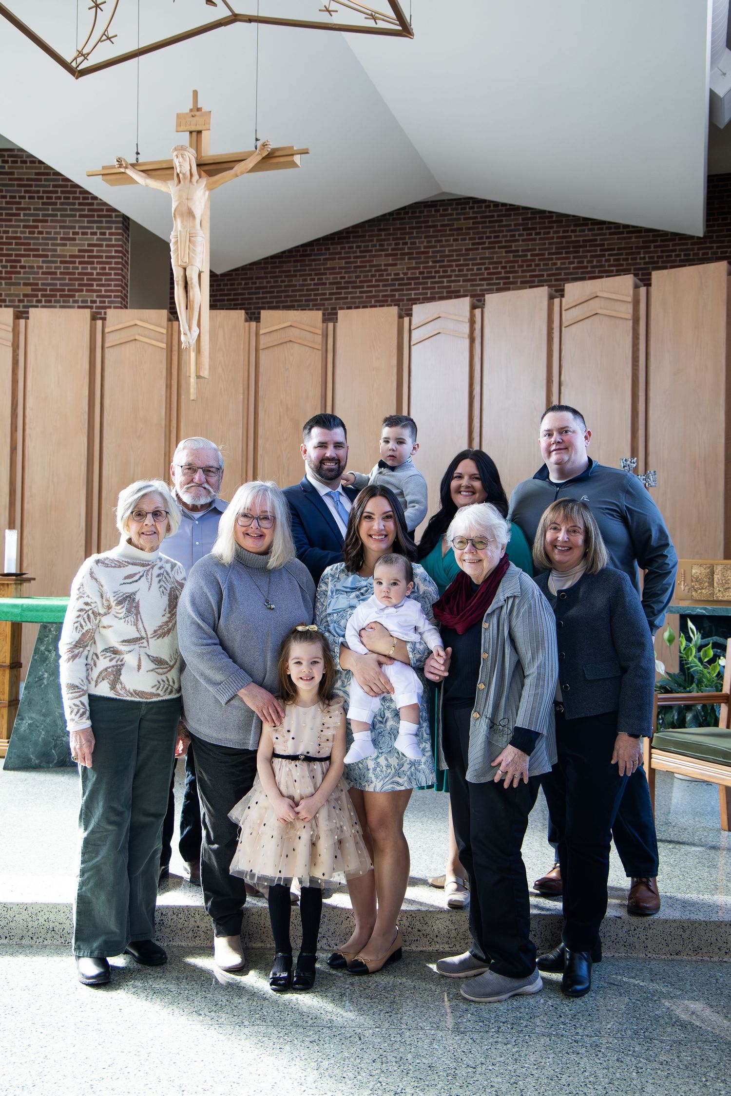 A group photo of family members gathered inside a church after a special ceremony.