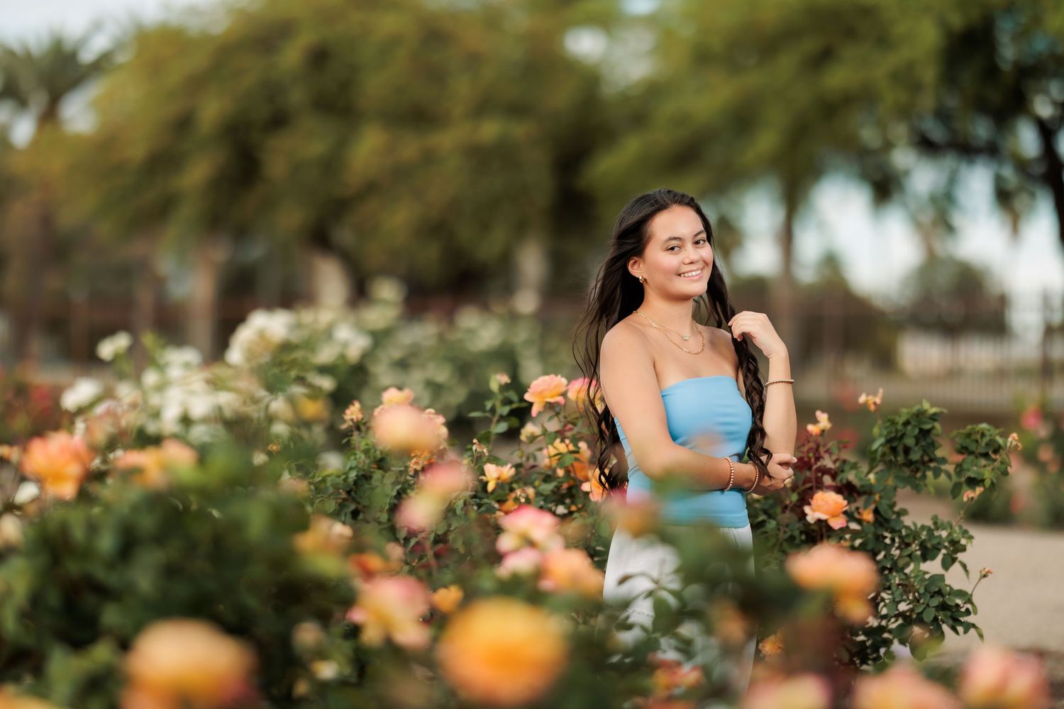 senior girl posing in the rose garden in Tucson, AZ