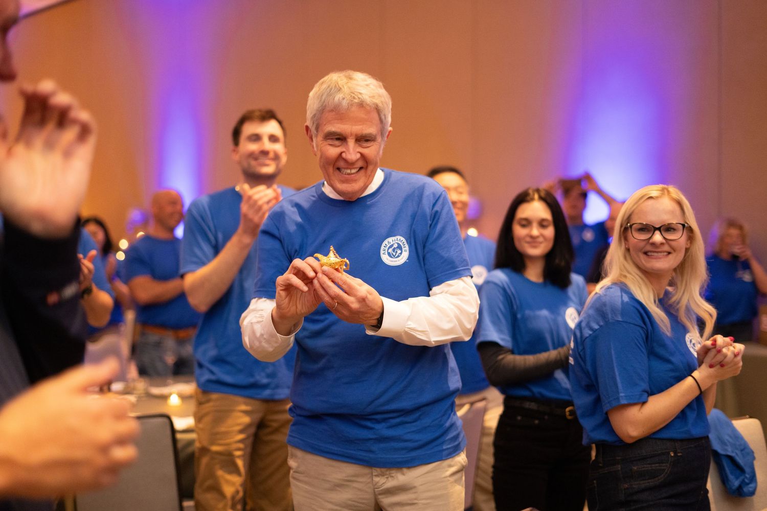 Orlando corporate event photographer Ray Alvarez — Arm and Hammer corporate team event coverage with branded shirts and award moment