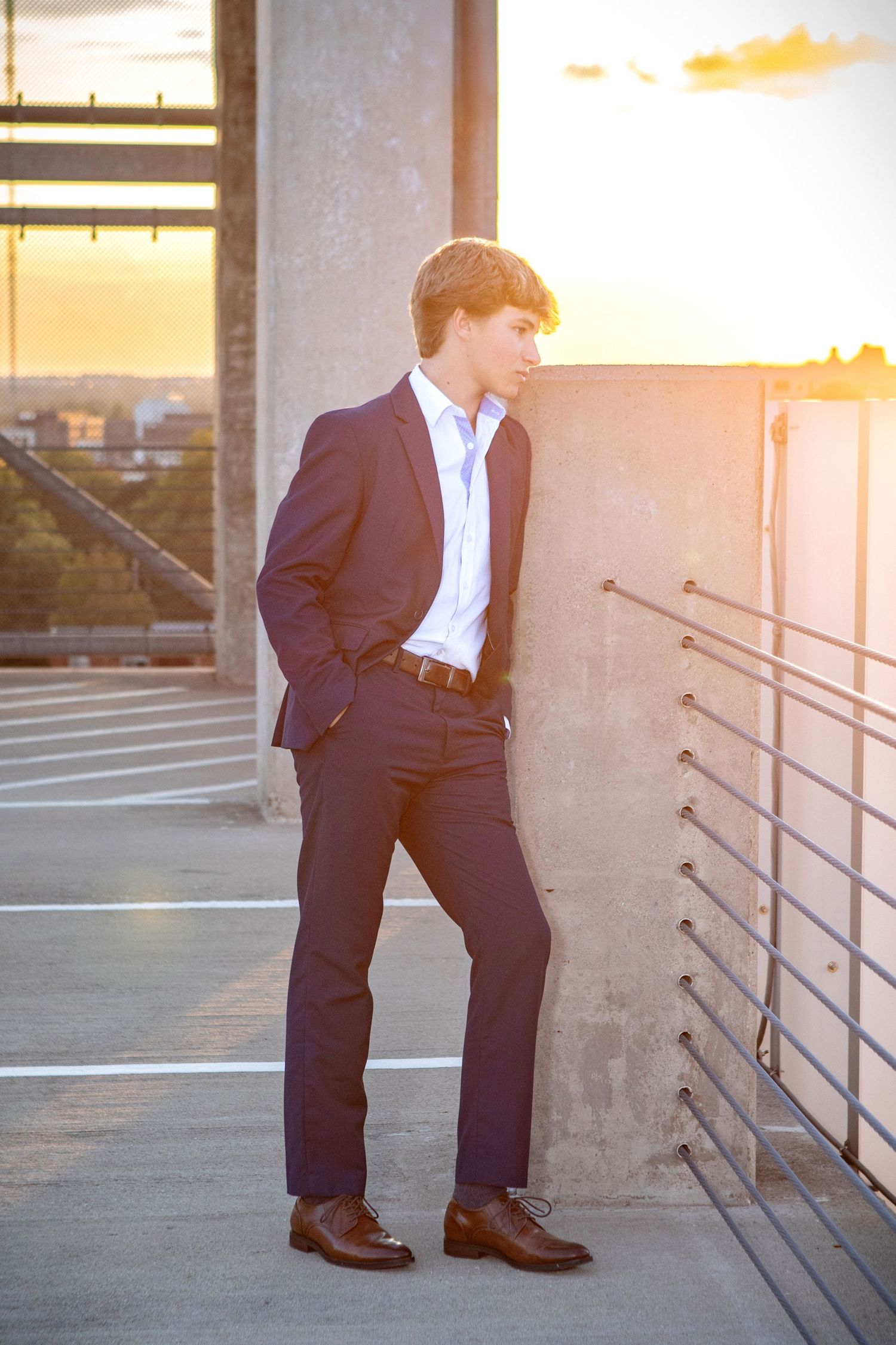 Olentangy senior guy pictures in the Arena District with a navy suit, city backdrop, and modern Columbus Ohio style.