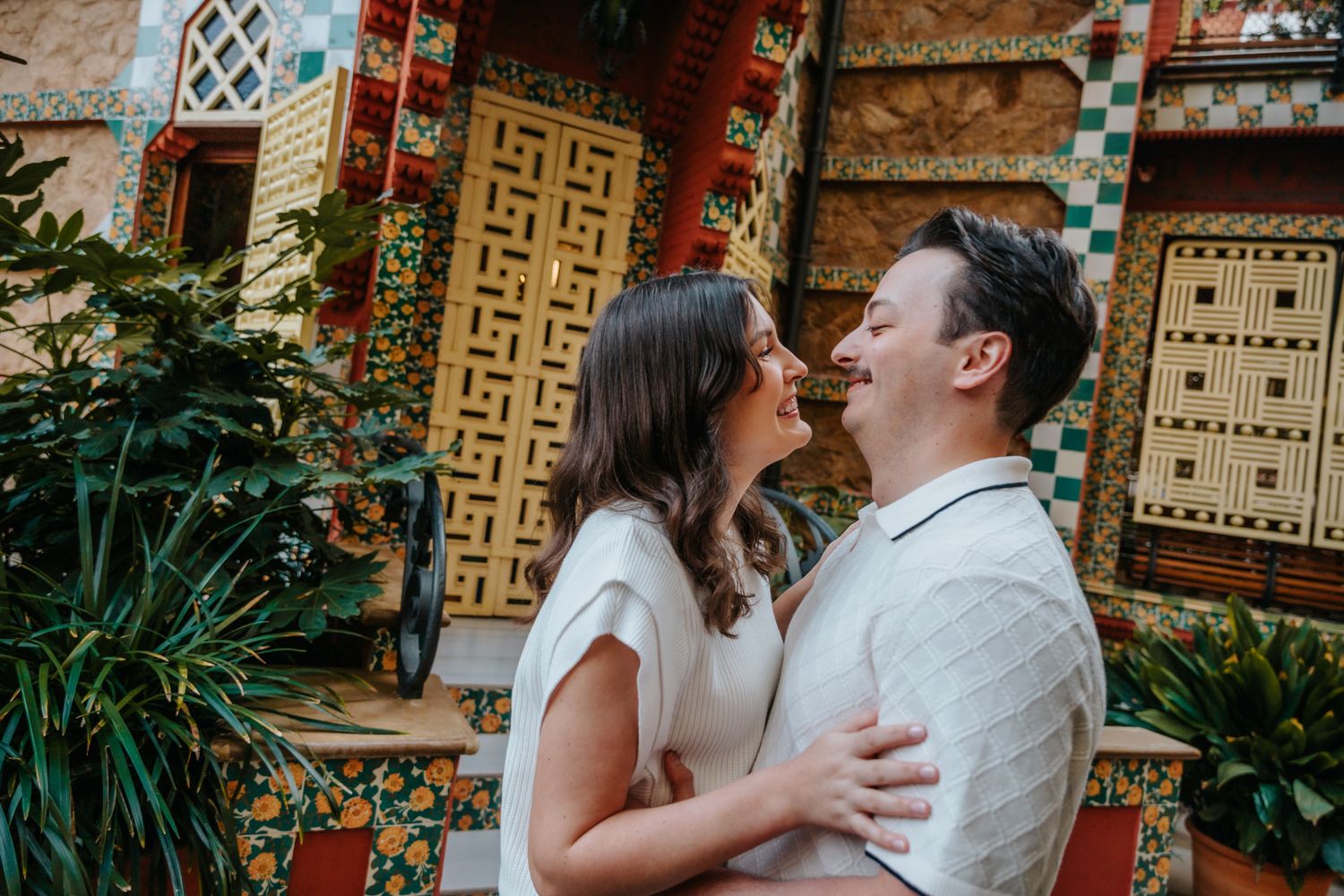 A couple hugging intimately in Barcelona's Casa Vicens just moments after a surprise engagement.
