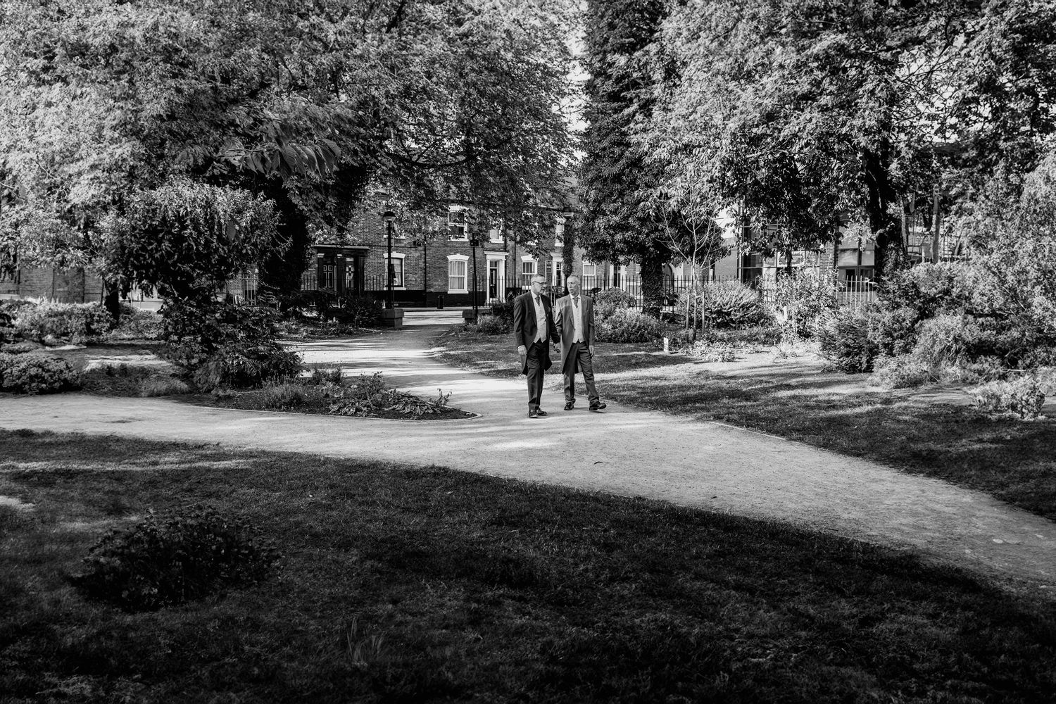 Newly weds walking through Hull's city centre gardens.