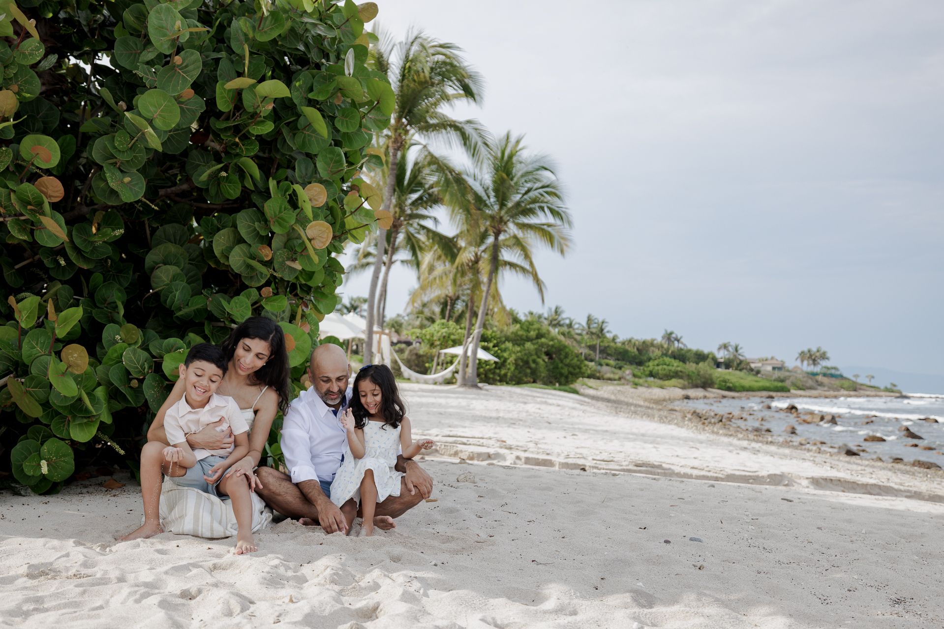 St Regis Punta Mita Family Photographer capturing a beach portrait on white sand with palms during Punta Mita Family Photos.