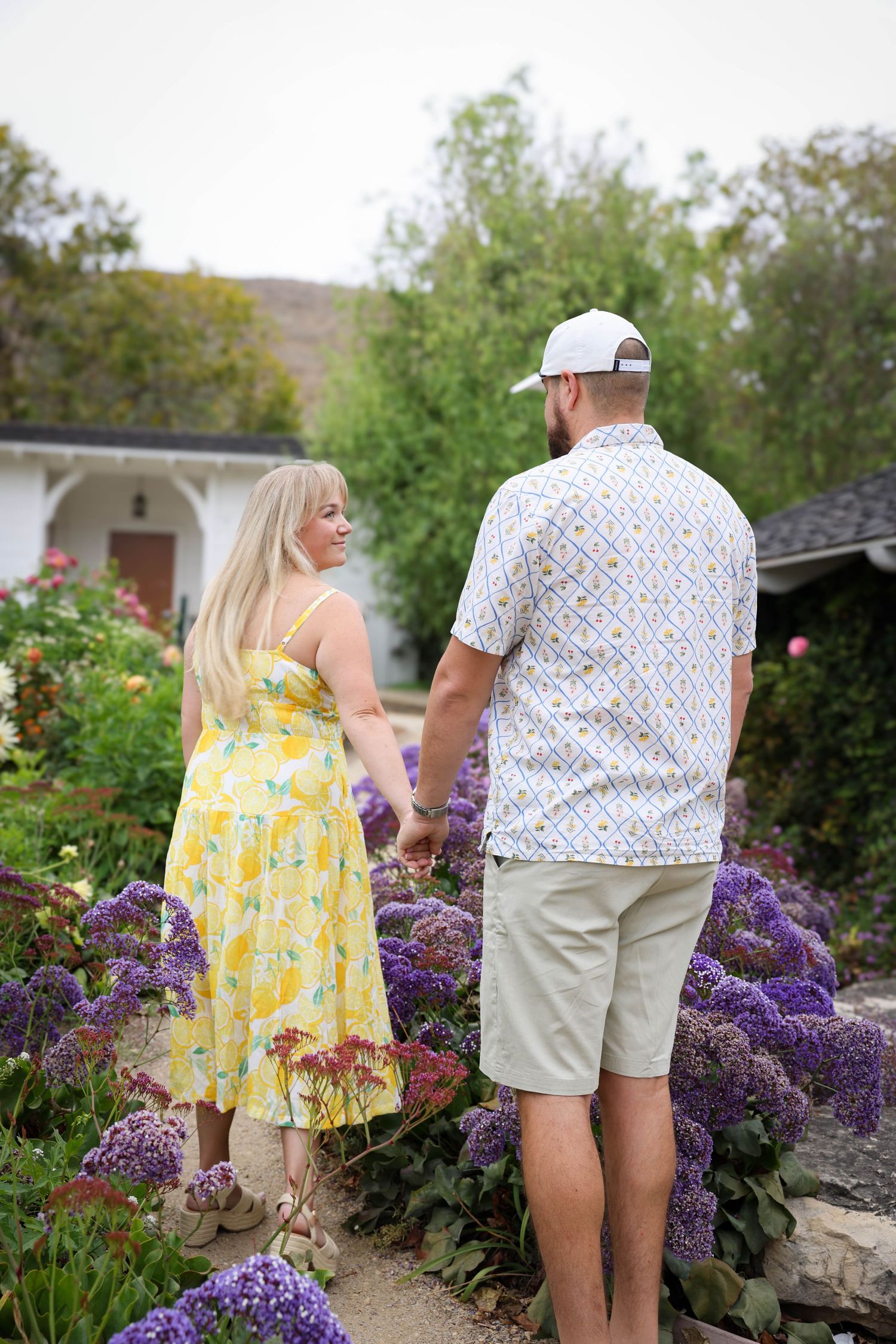 Couple walks through Secret Garden at Madonna Inn in San Luis Obispo