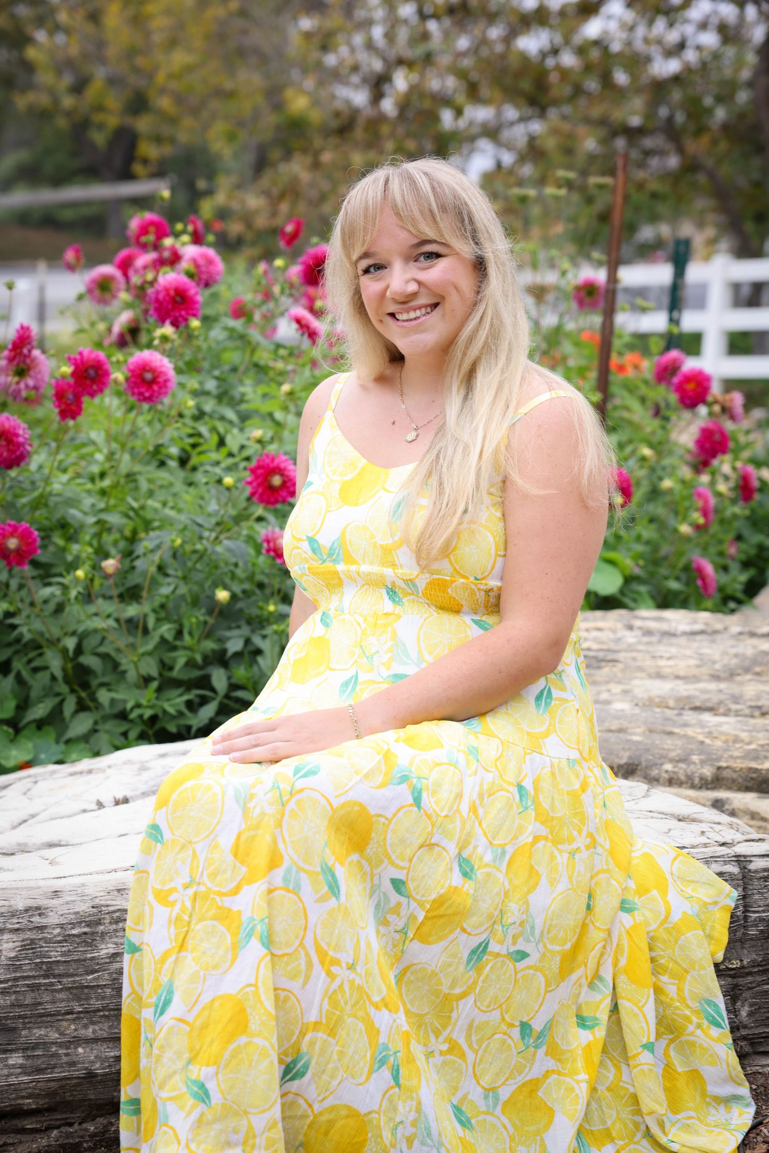 Woman poses on in a lemon sundress in the Secret Garden at the Madonna Inn in San Luis Obispo