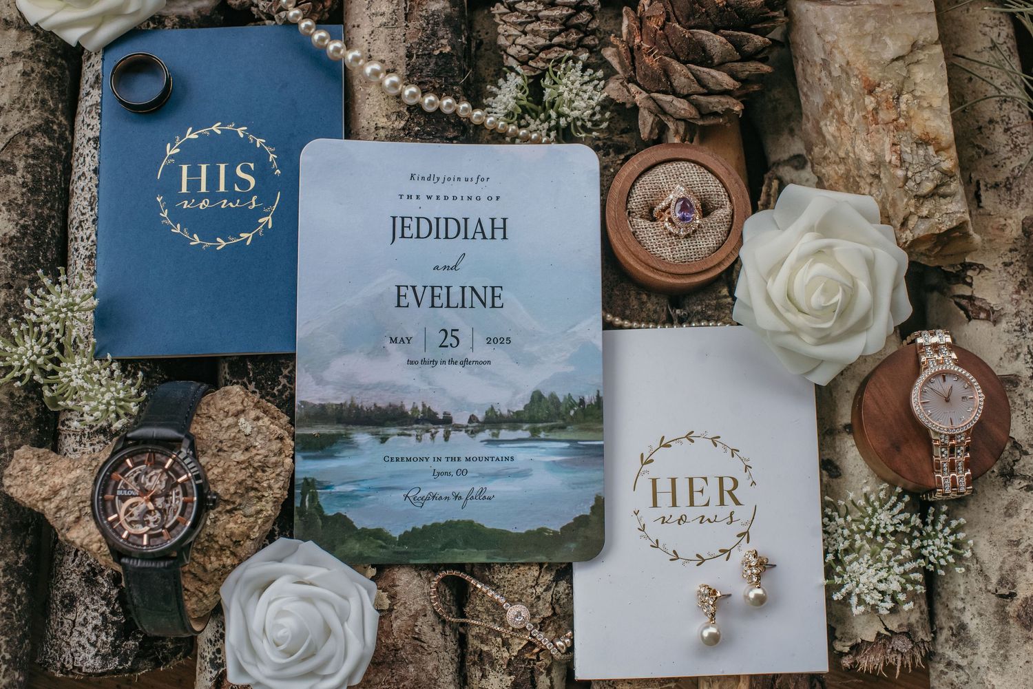 Wedding flat lay with floral invitation for Jedidiah and Eveline, rings, watches, and white roses on rustic wood.