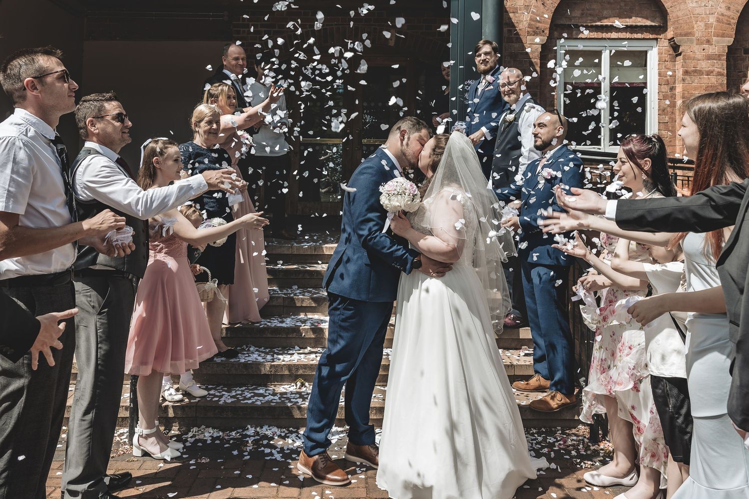 Documentary wedding photography during a confetti throw at a Nottinghamshire wedding venue
