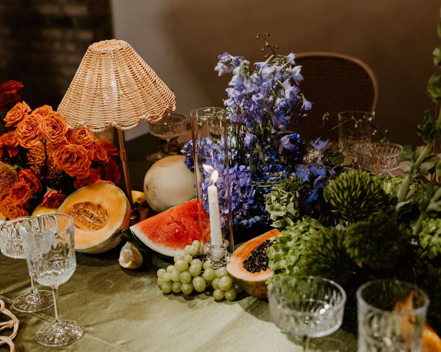 Elegant wedding table setting with white plates, gold cutlery, and white linen tablecloth at a formal dinner reception.