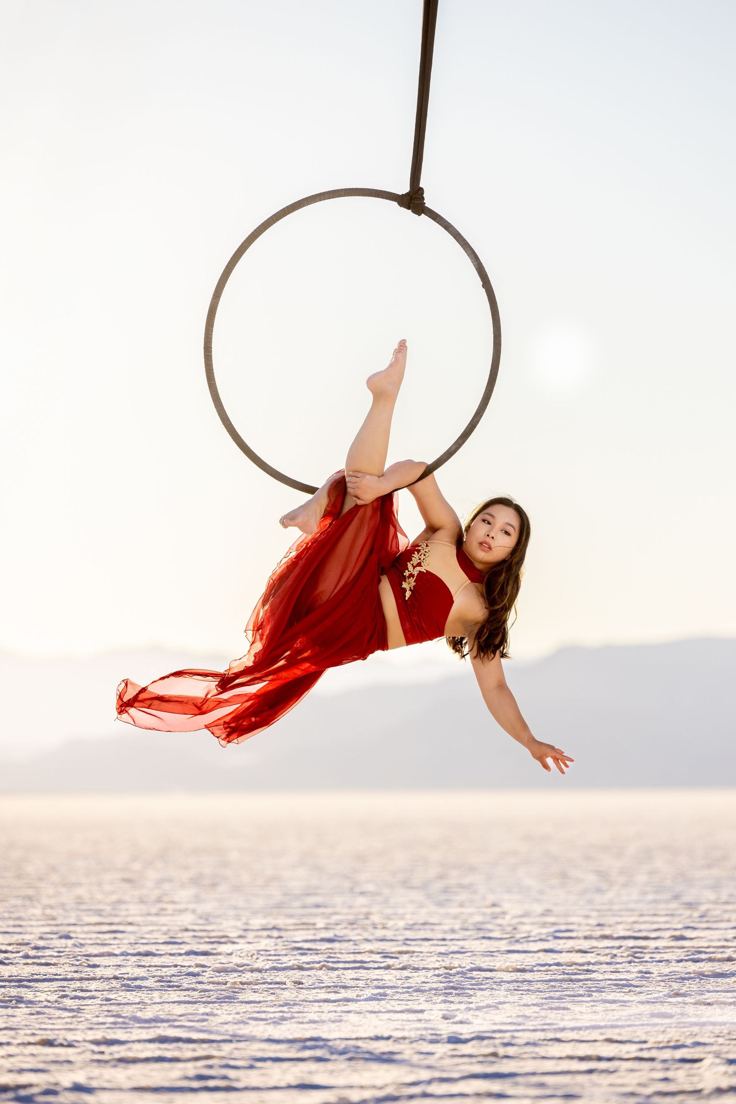 Aerialist in studio on white backdrop; professional aerial arts photography, aerial portraits, and aerialist photoshoot by expert photograph