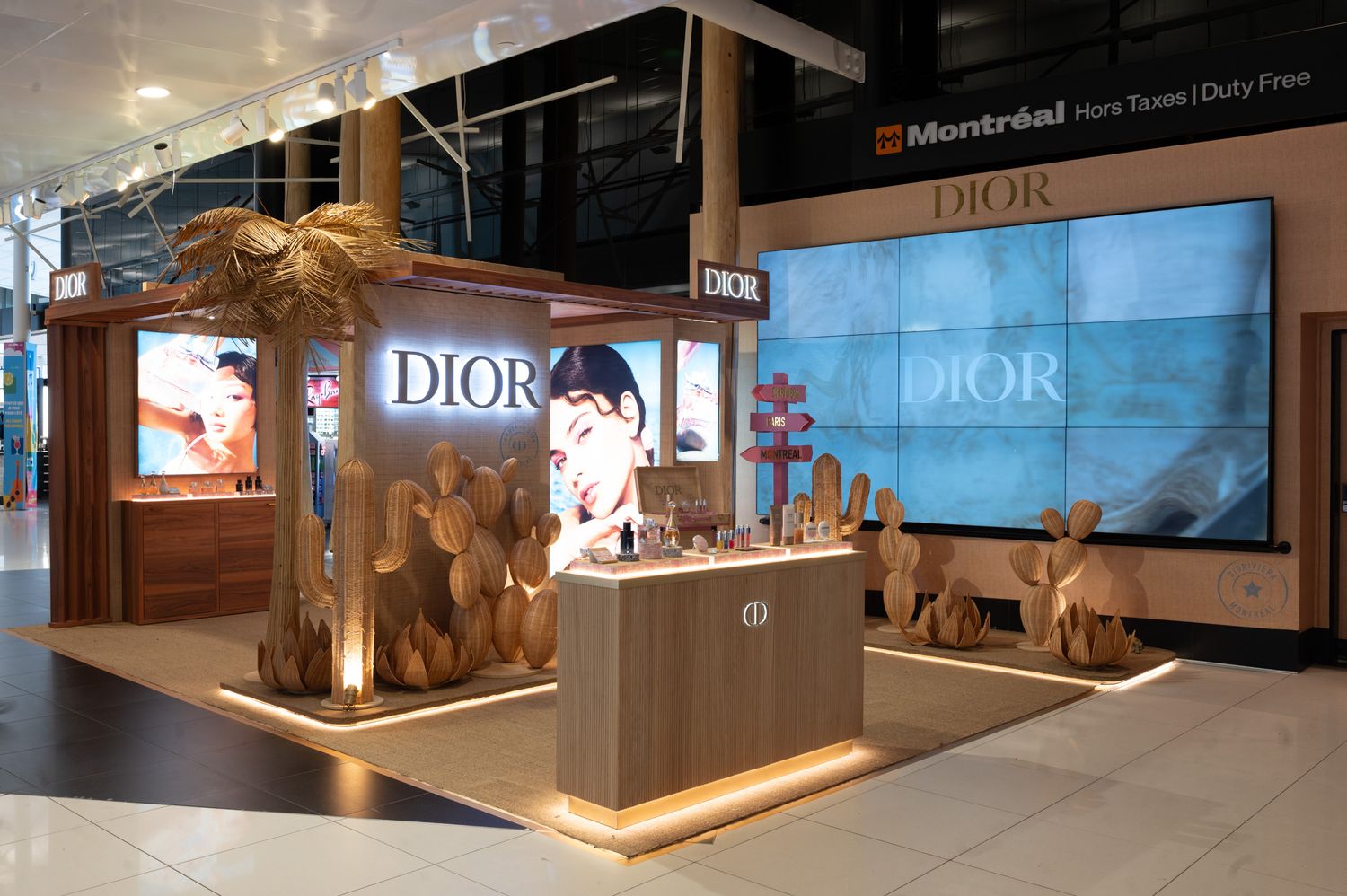 Dior luxury pop-up shop display at Montreal Duty-Free airport with elegant wood decor and cosmetics showcase.