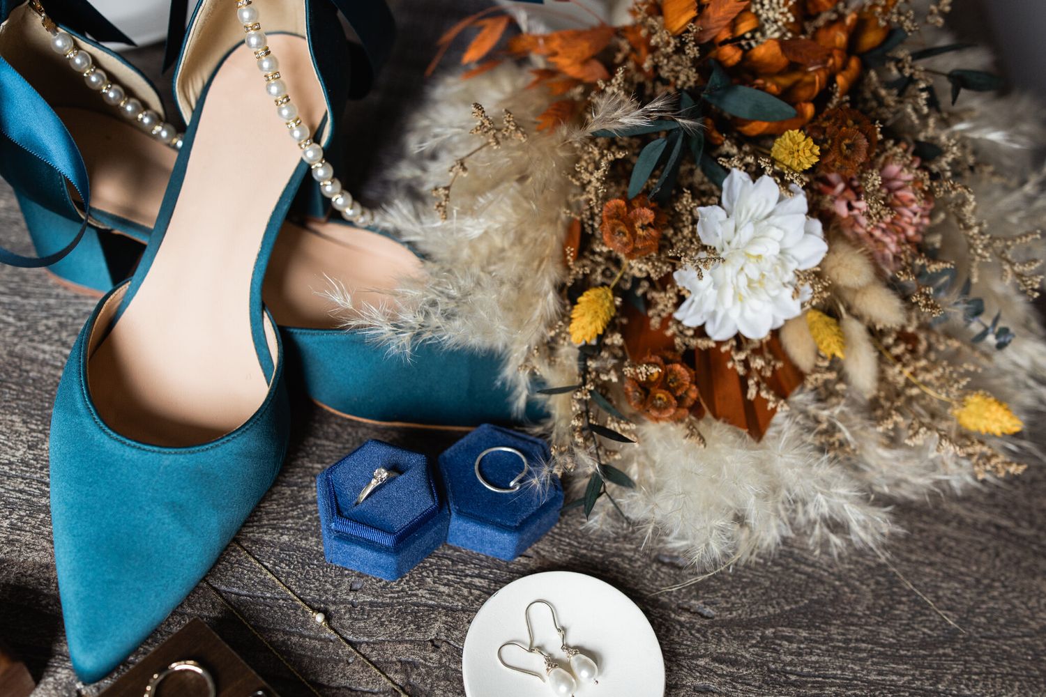 Teal wedding shoes, rings and dried florals at a Vista Canmore wedding