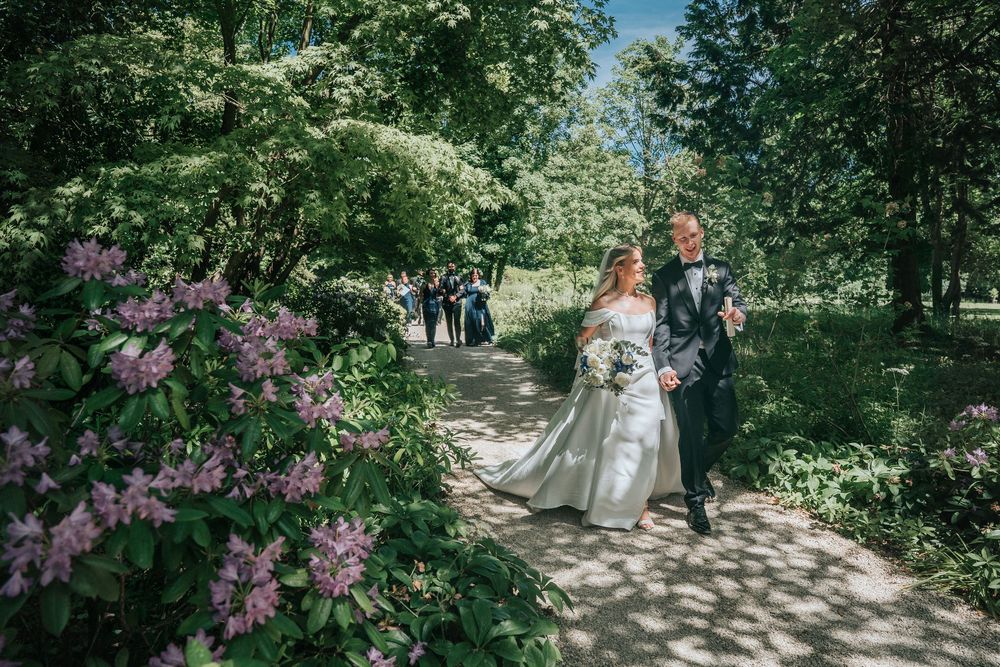 Bride and Groom walking from ceremony at Deer Park Country House in Devon