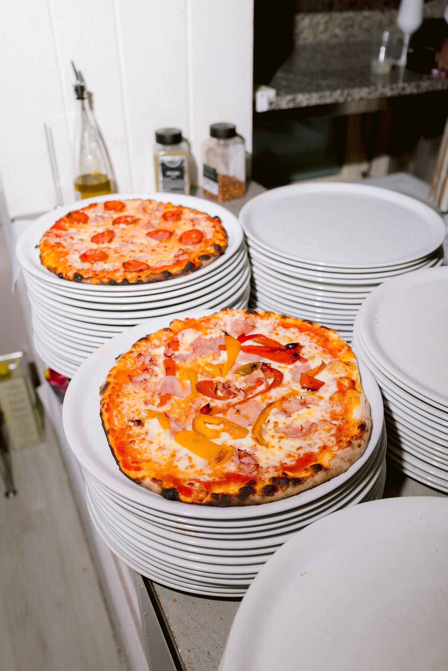 Pizza on plates ready to be consumed at a welcome party by the shores of Lake Garda