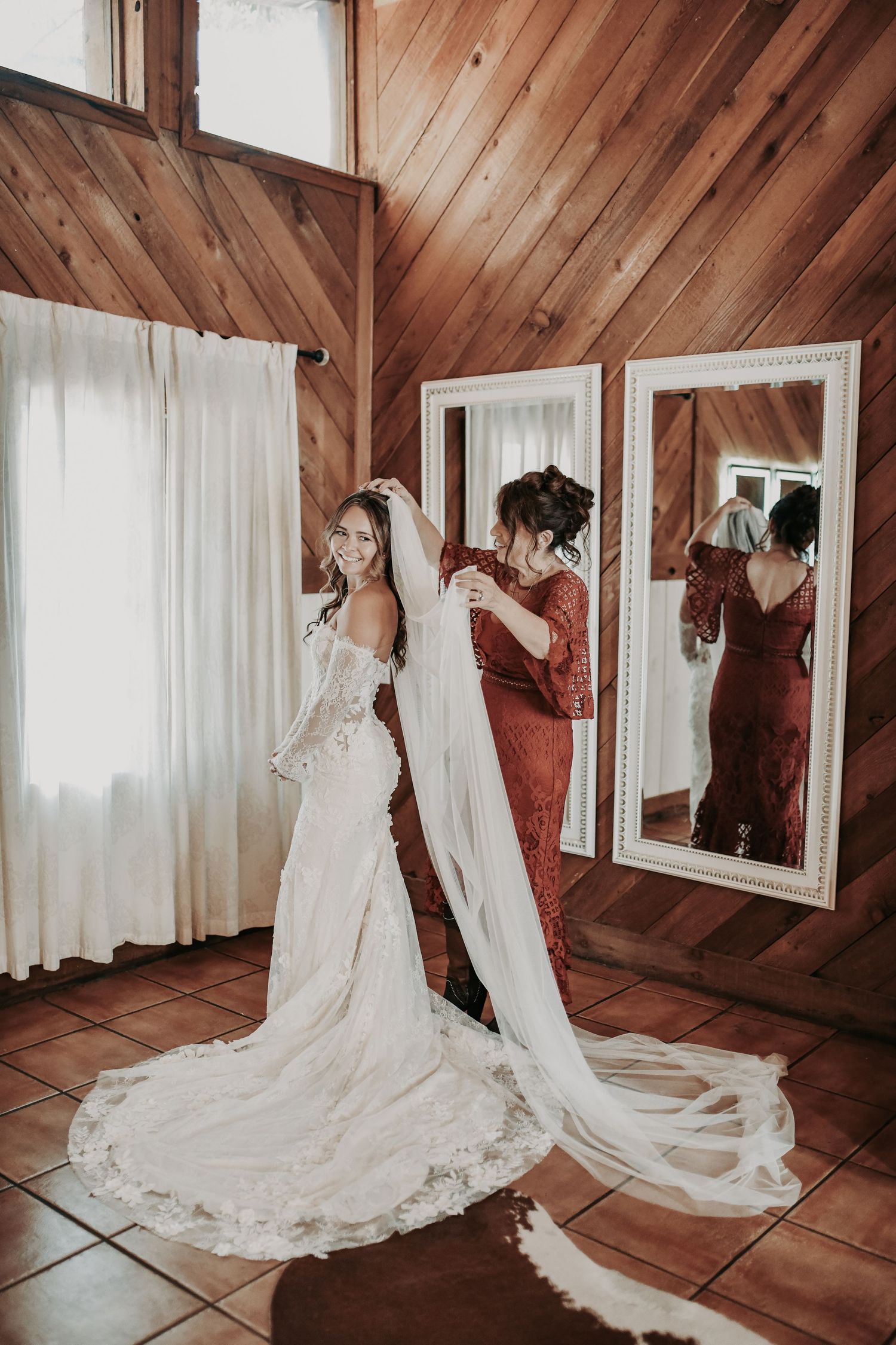 Mom carefully placing her daughter's wedding veil