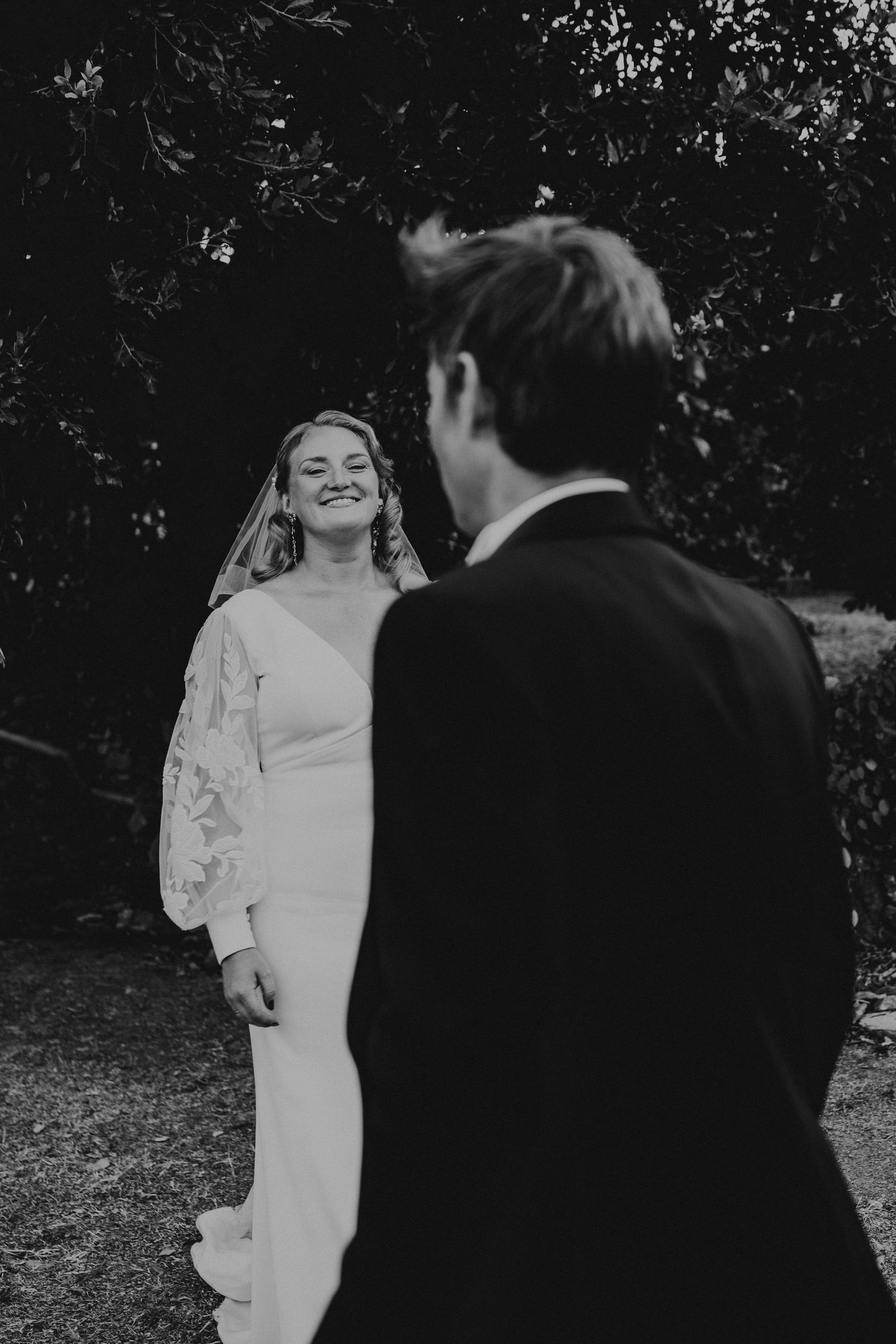 A tender autumn embrace captured during a wedding photoshoot with fall foliage.