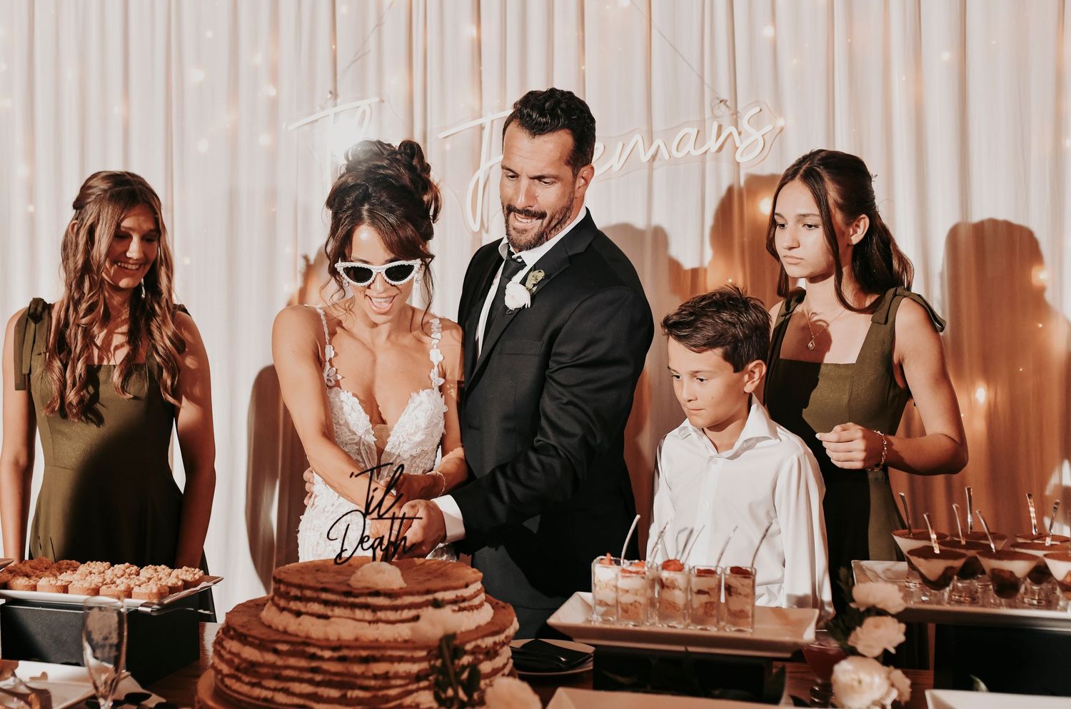 Fun family wedding cake photos during the reception