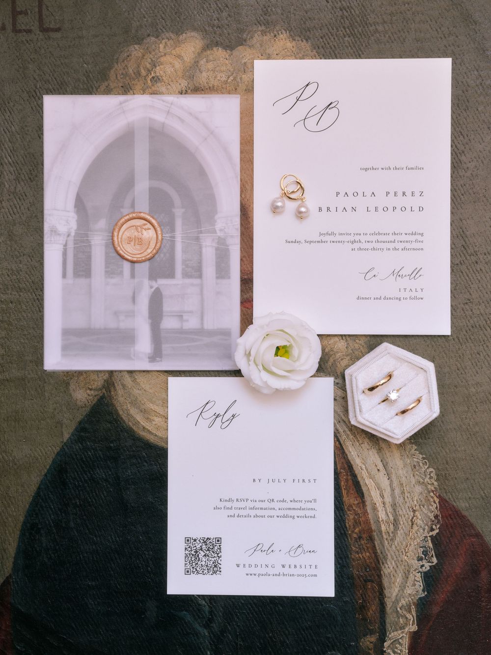 Elegant white and gold wedding stationery set with minimalist design elements and hexagonal details on a textured background.