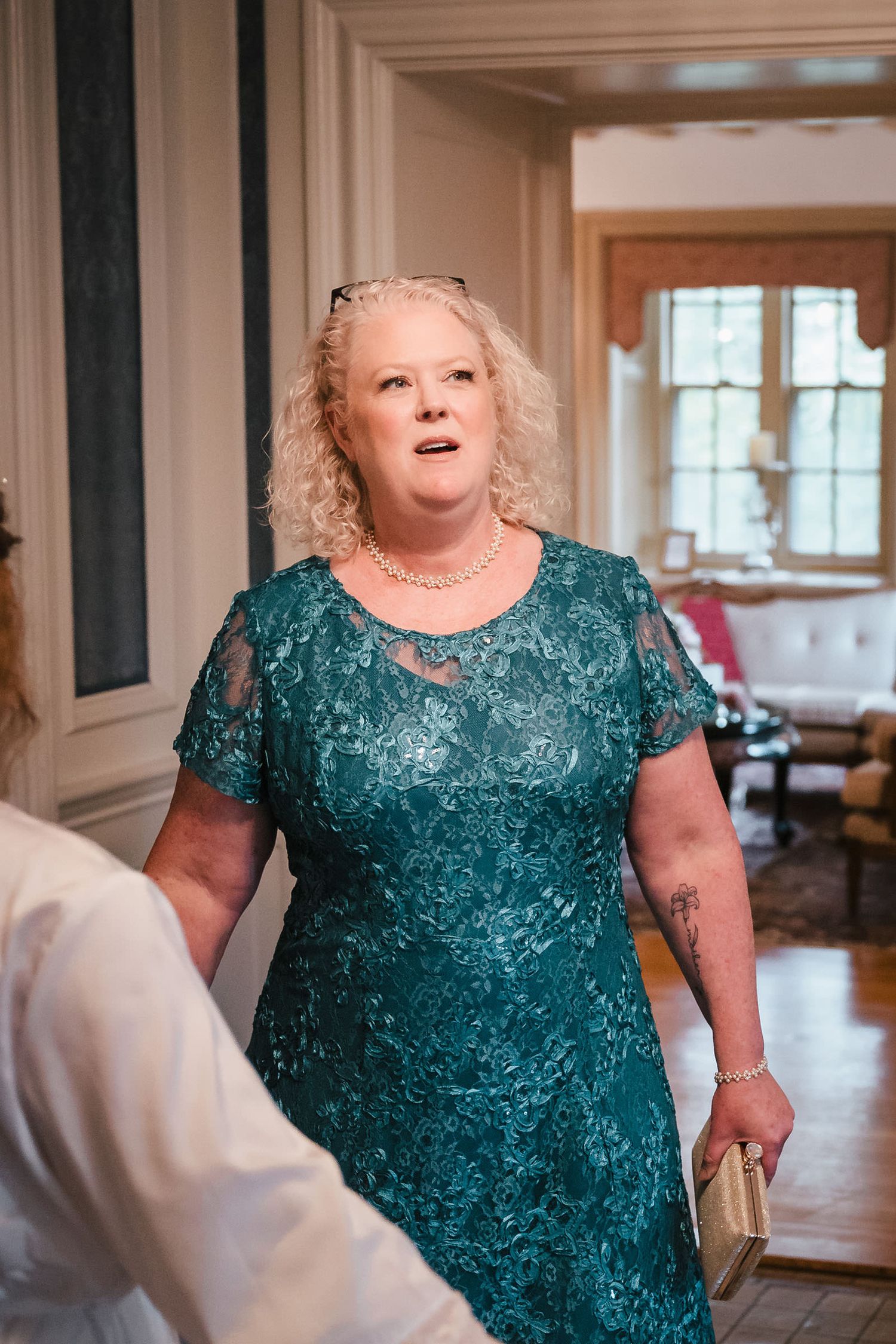 Bride and her mother standing together moments before seeing the wedding dress made from the mother's own gown, at Searles Castle.