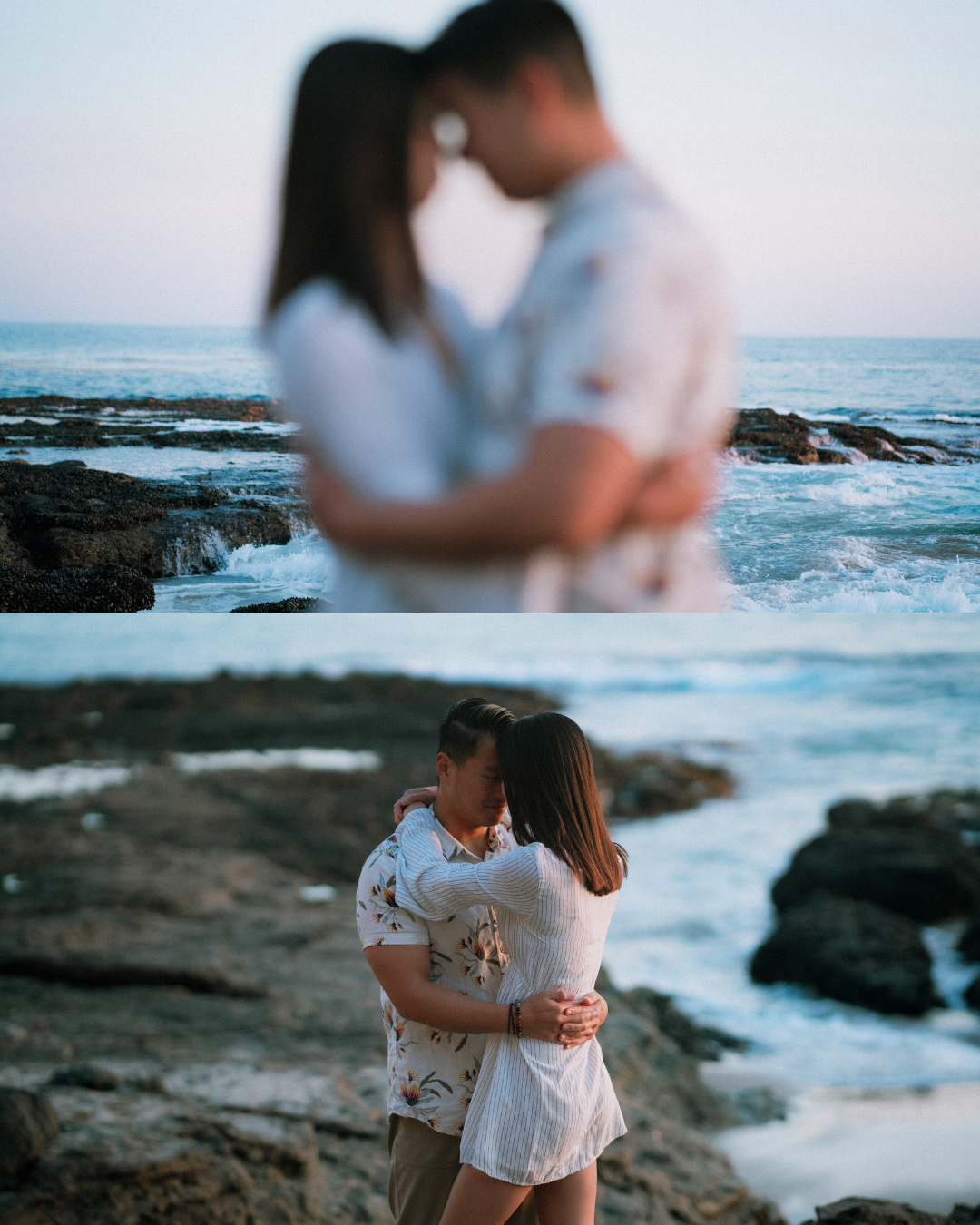 A couple shares a tender embrace on a rocky shoreline with ocean waves behind them.