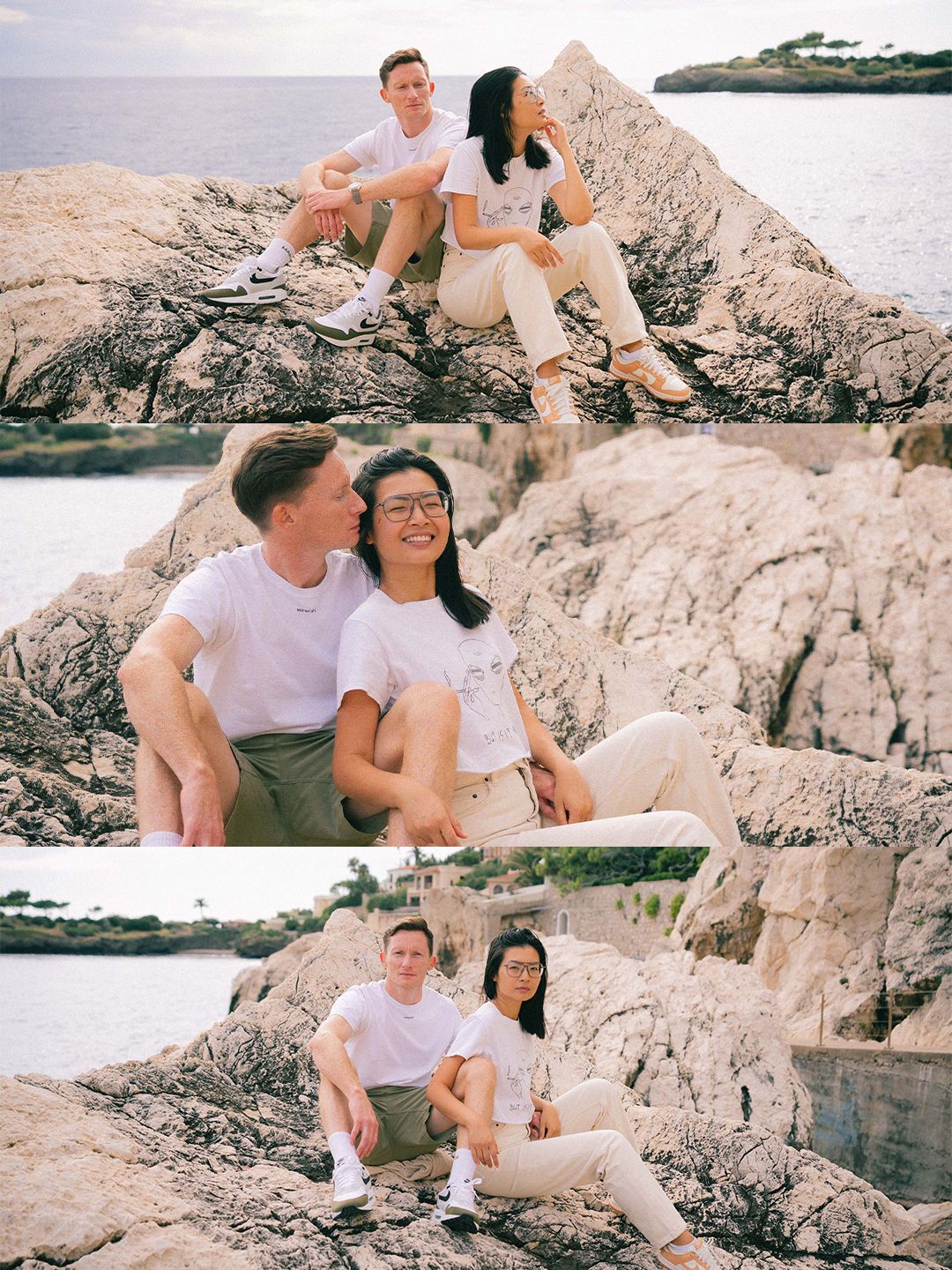 Couple sitting and laughing together on rocky coastal cliffs with serene ocean views in warm light.