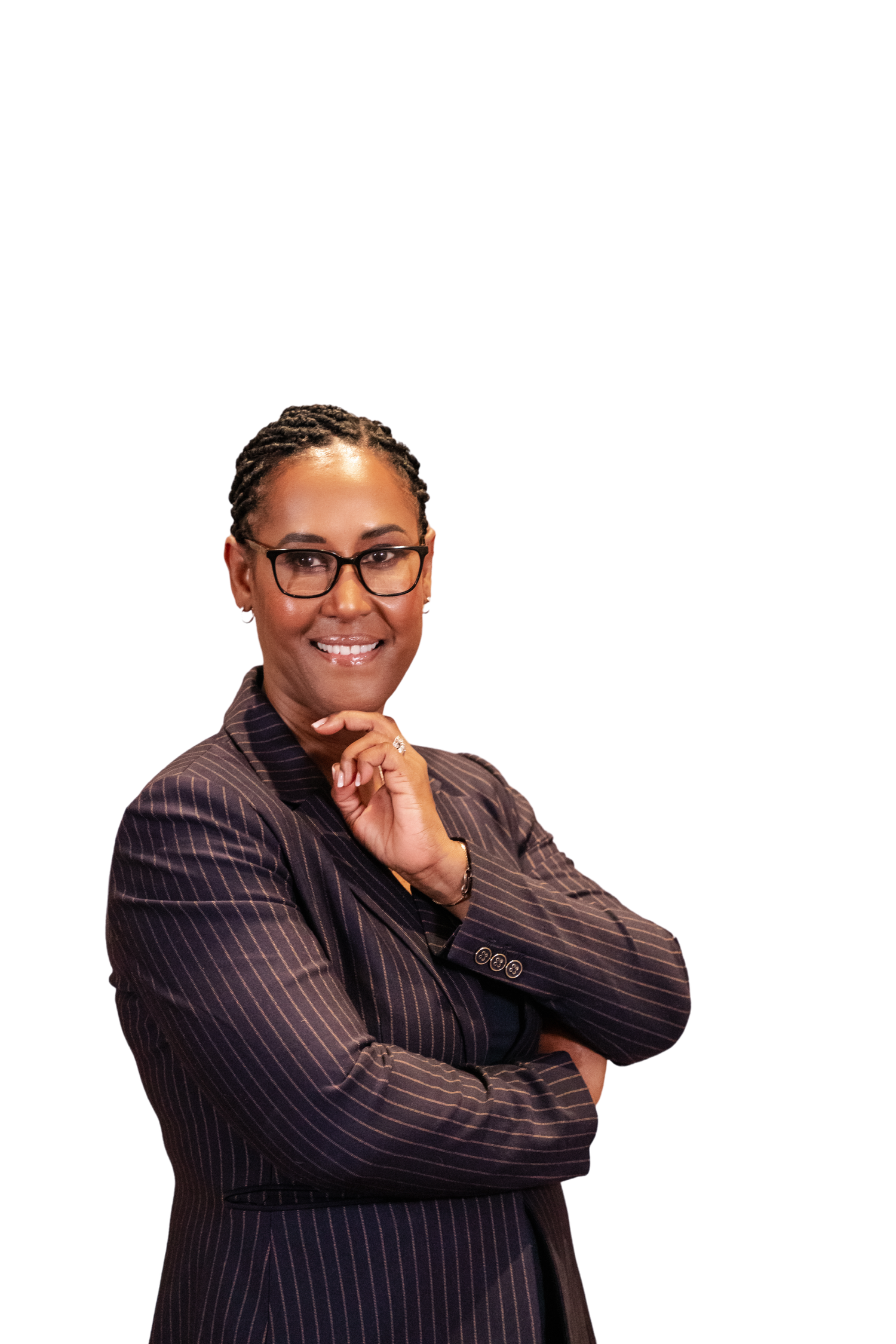 Professional woman in pinstripe blazer with arms crossed, smiling confidently against white background.
