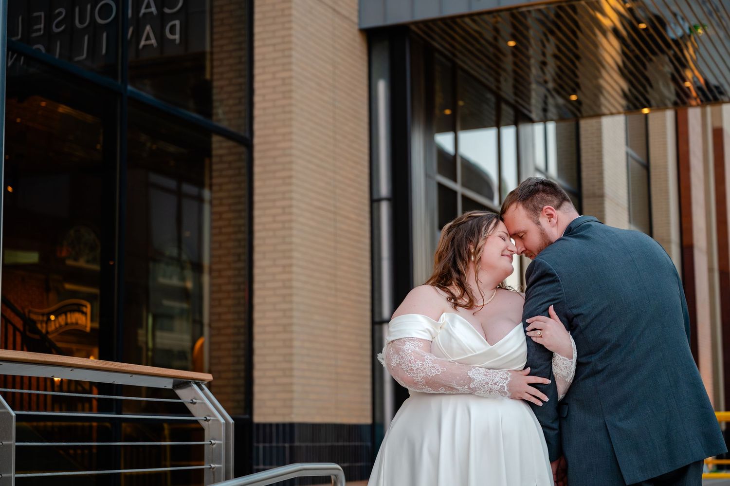 Bride and groom share a romantic moment outside Carousel Pavilion venue on their wedding day.