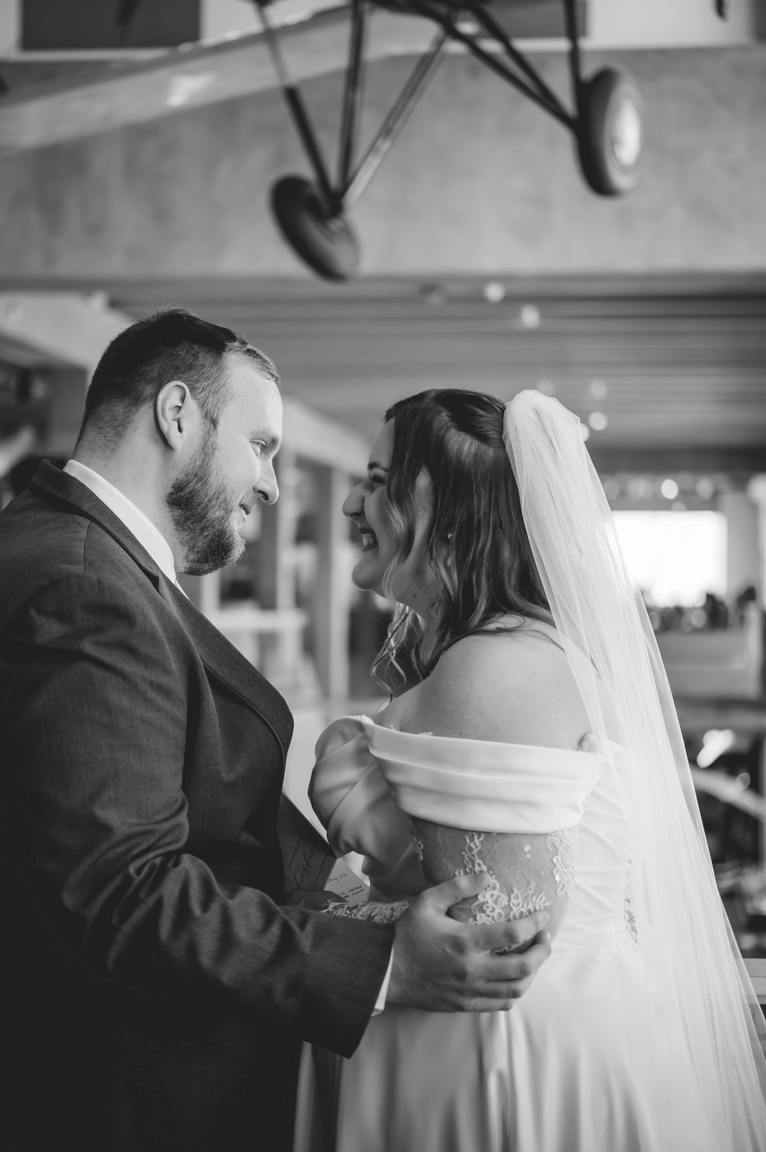 Black and white photo of bride and groom sharing an intimate moment during their wedding dance.