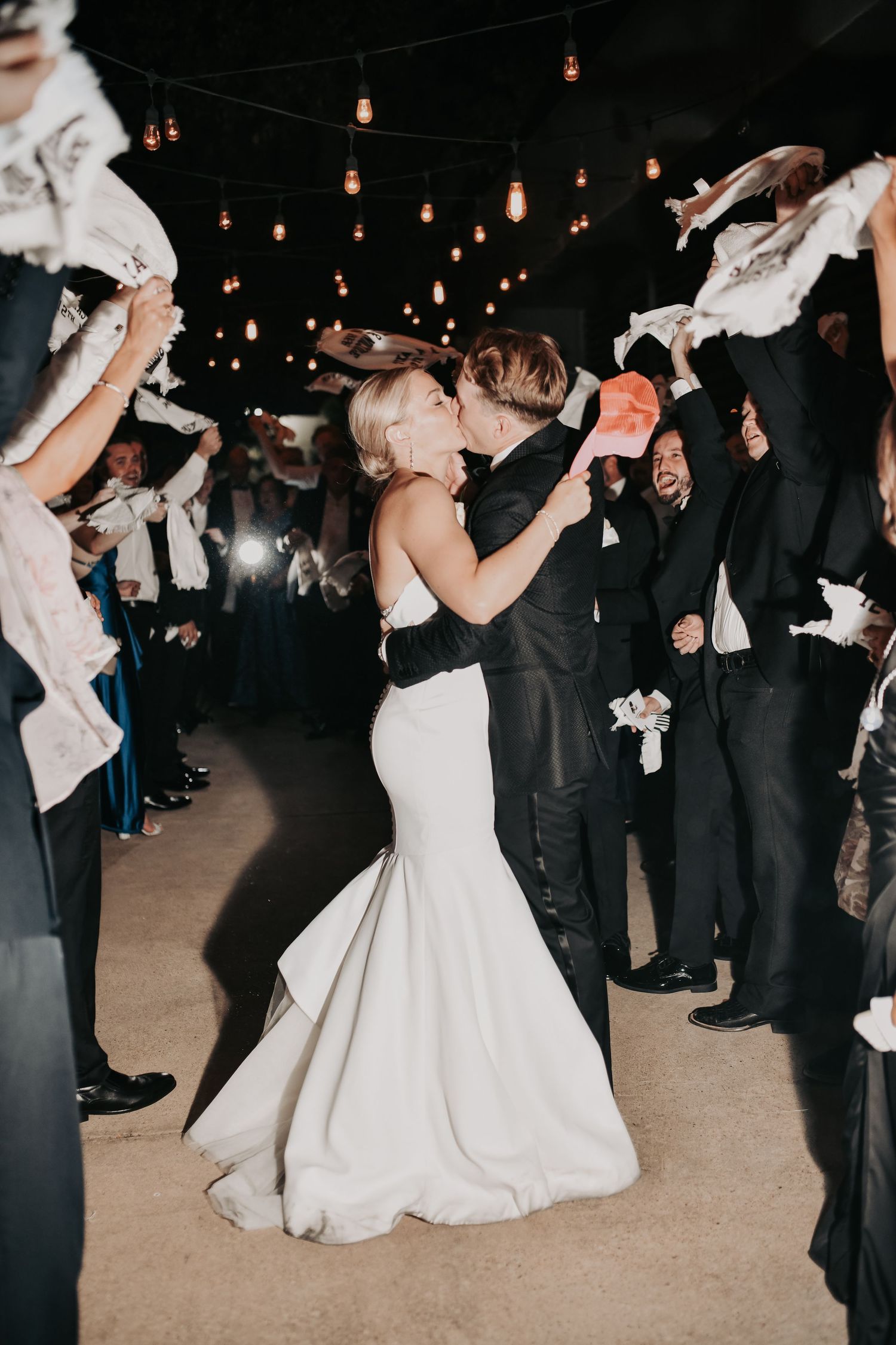 Wedding guests waving Aggie towels during the newlyweds’ grand exit