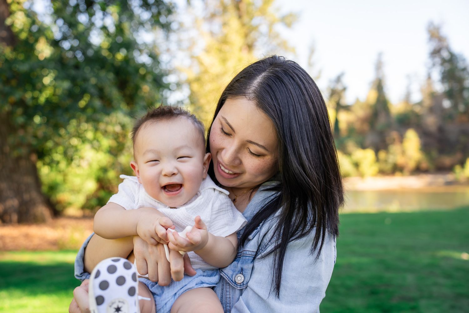 Mom cuddles and laughs with baby boy