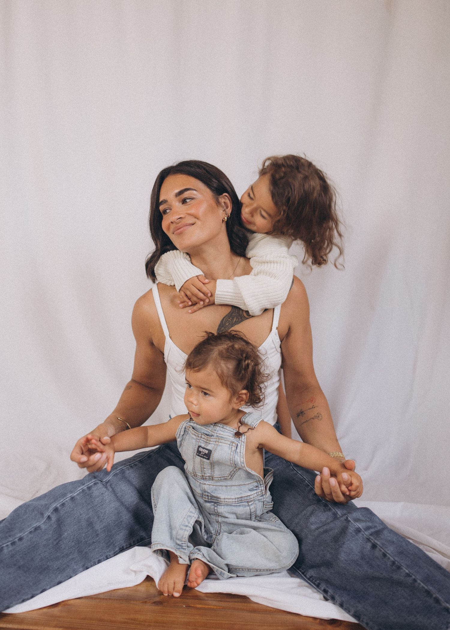 Mother smiling with two children during family studio session in Raglan, New Zealand