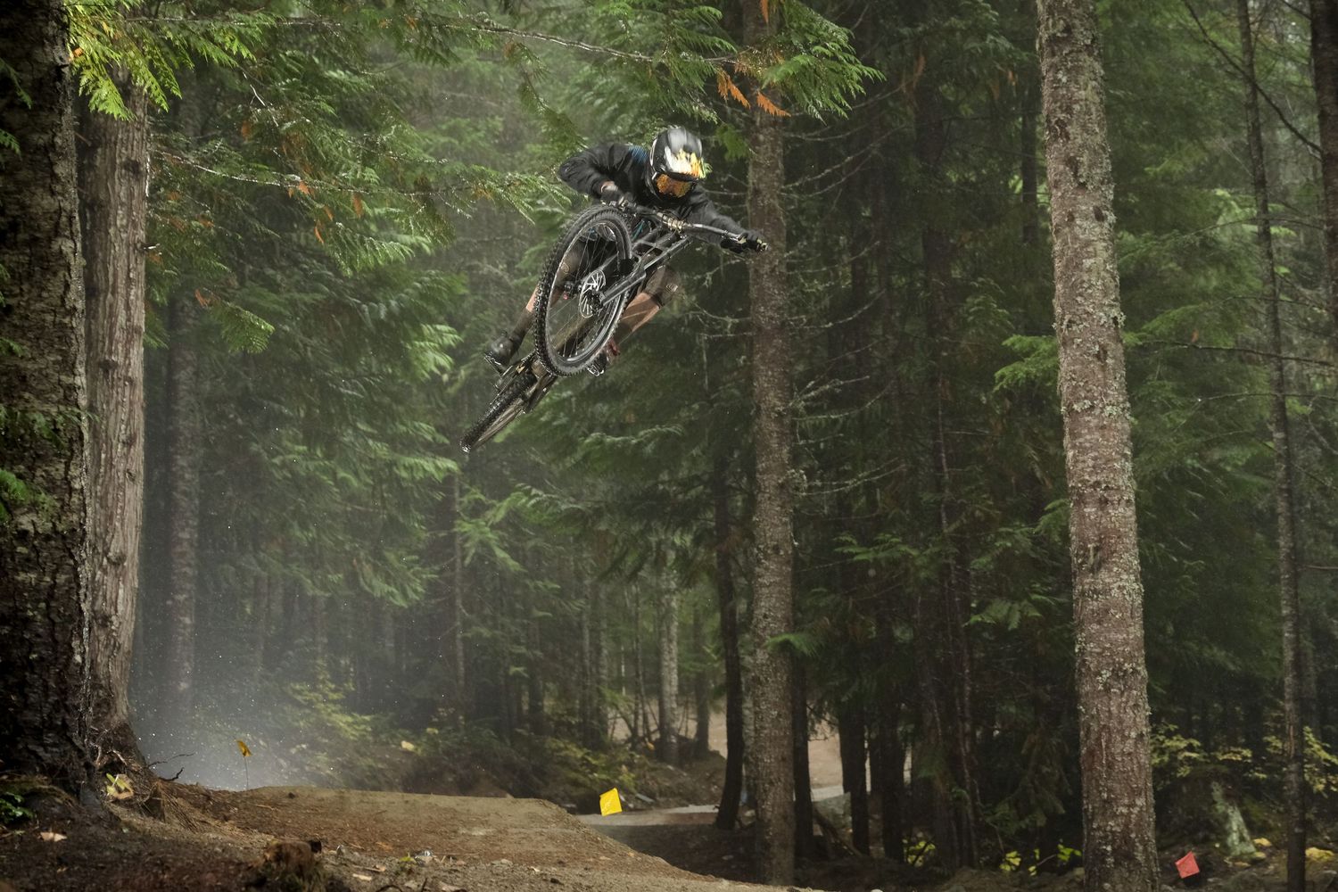 Mountain biker soars through foggy forest during an extreme jump.
Whistler Mountain Bike Park