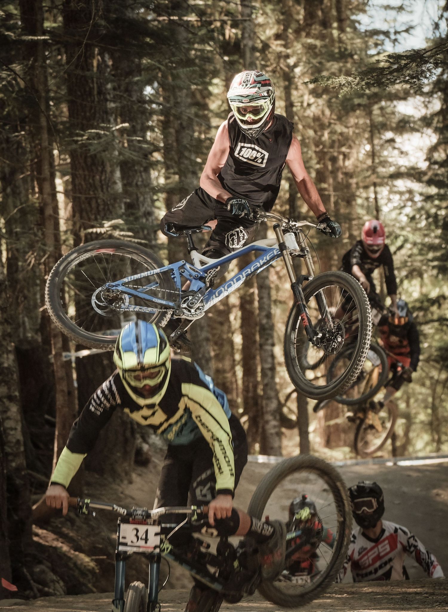 Multiple mountain bikers perform aerial tricks in forest competition setting.
Whistler Mountain Bike Park
Crankworx
