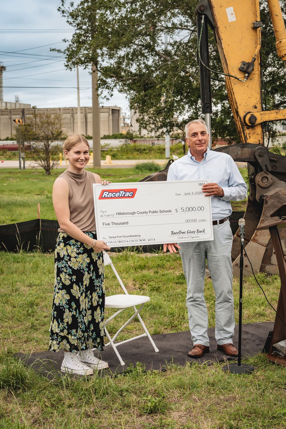 RaceTrac representatives present a $5,000 check donation to Hillsborough County Public Schools at an outdoor ceremony.