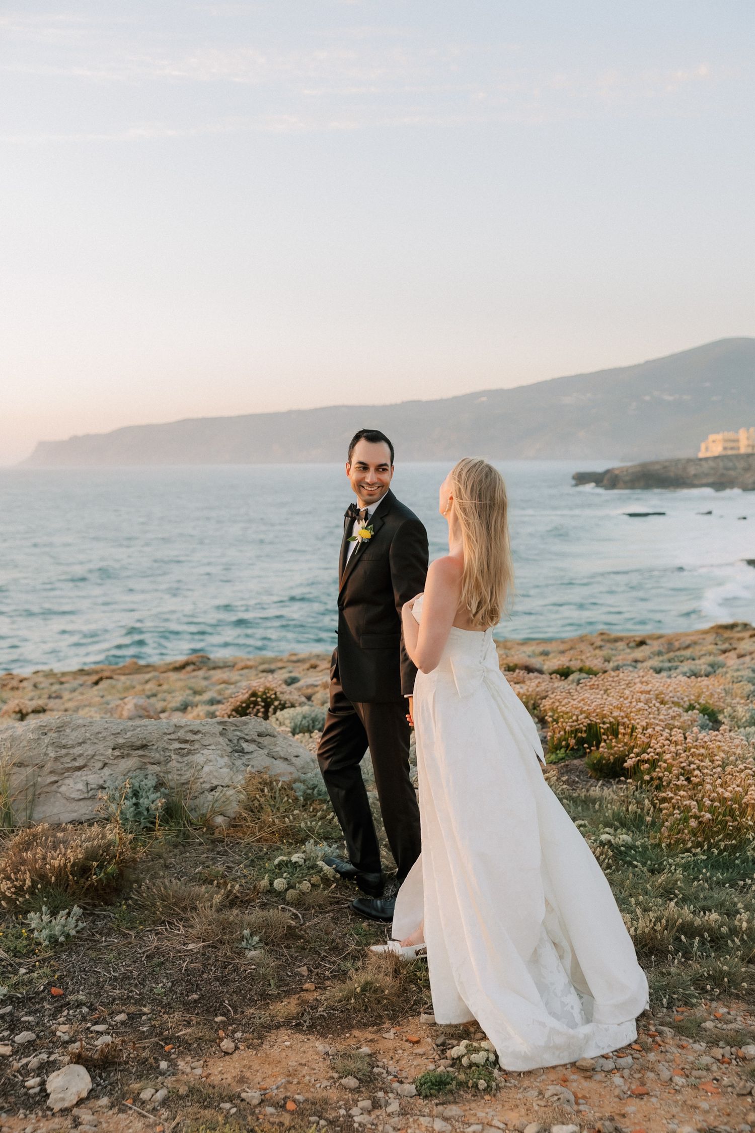 Romantic sunset portrait of newlyweds overlooking the Atlantic Ocean in Cascais.